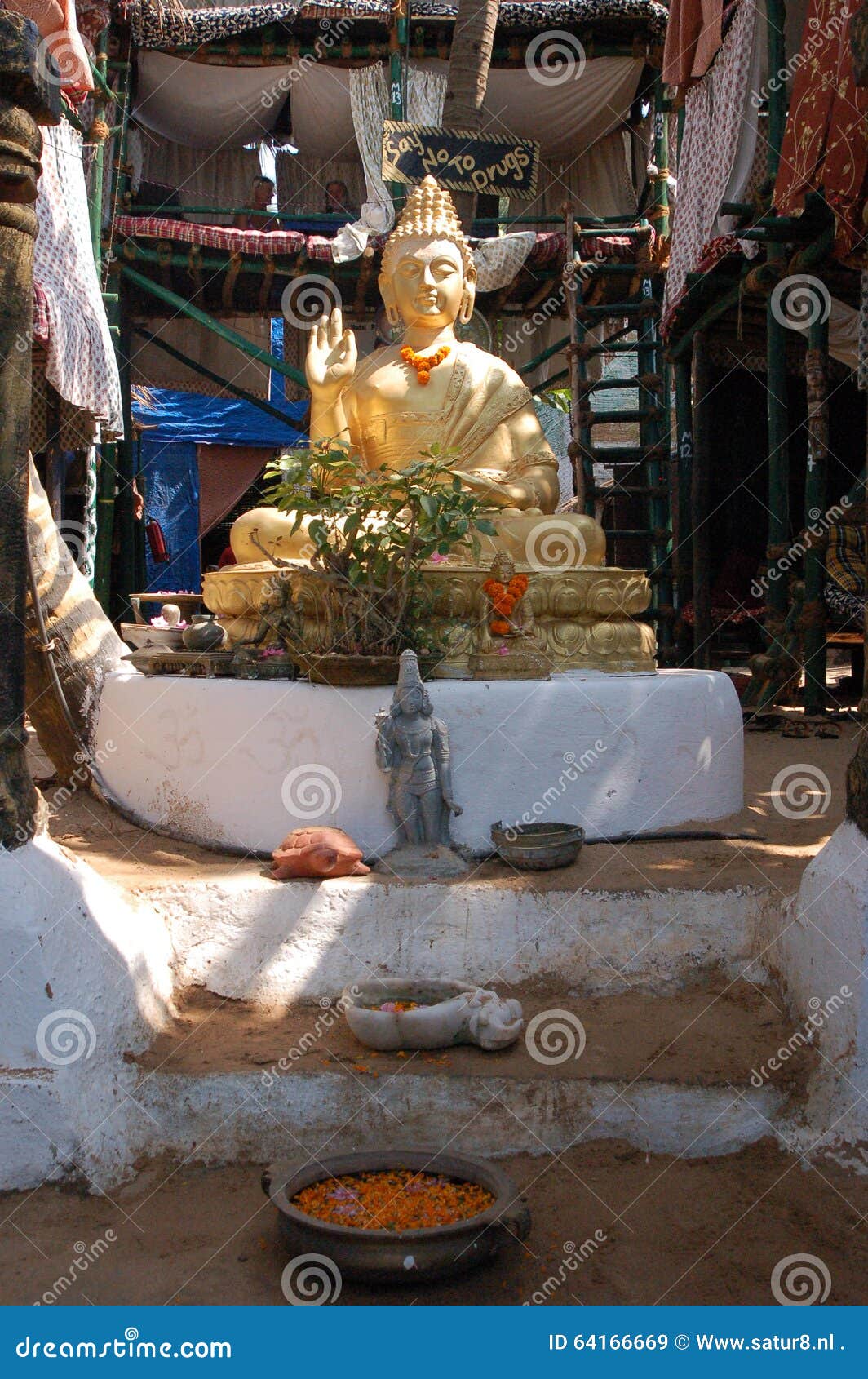 Buddha watching over you. A Buddha statue in Goa, India with some relics