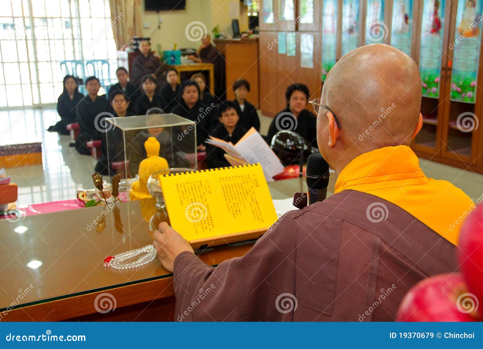 Buddhish Teaching By Master. KUALA LUMPUR, MALAYSIA - MAY 1 : Photo of a senior buddish master sharing his knowledge on buddhism enlightenment to a group of new followers during a buddhish recruitment ceremony on May 1, 2011 at a Buddish Temple, Malaysia.