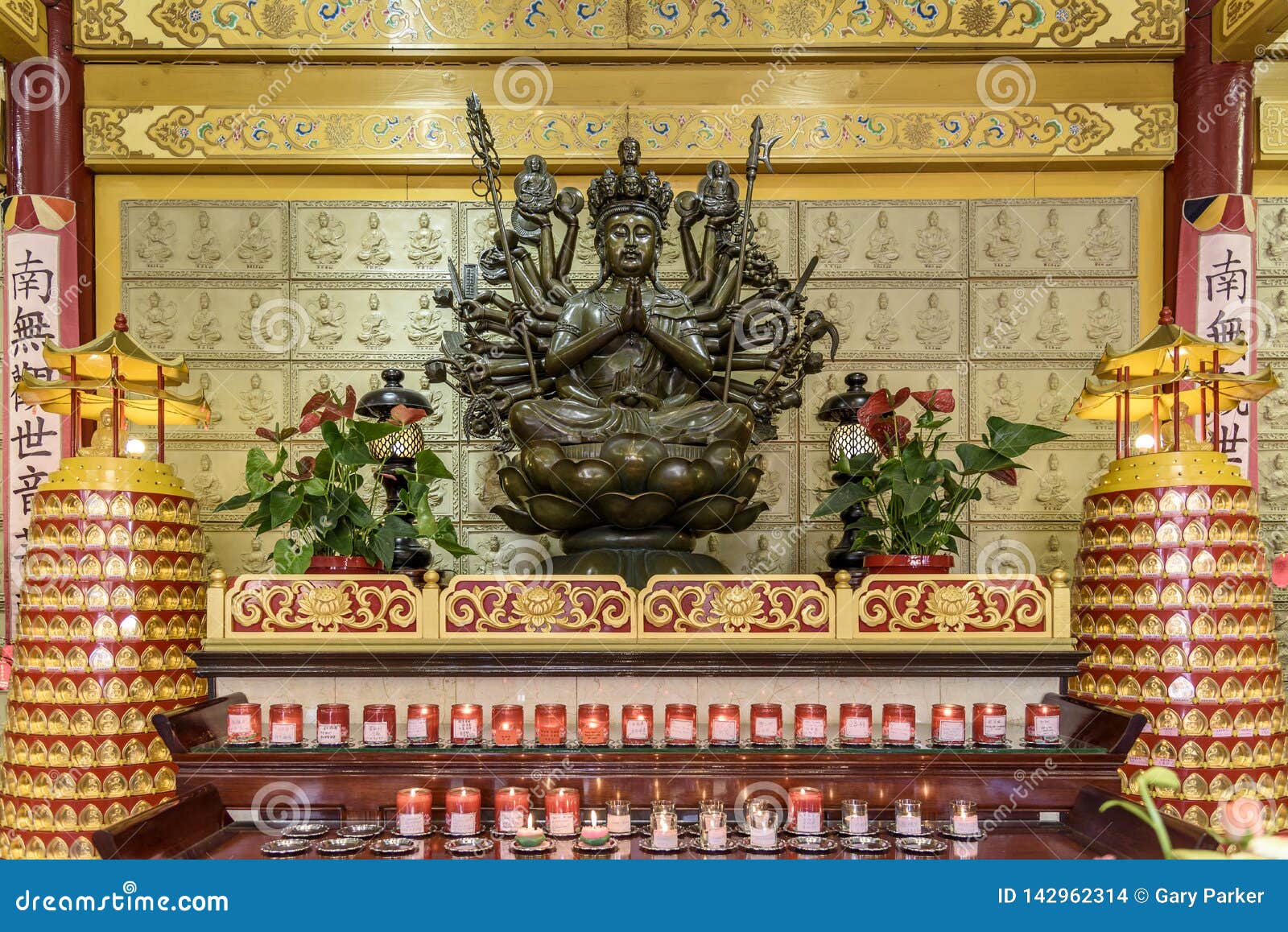 A Buddhist Altar, with an Ornate Statue and Candles Stock Photo Image