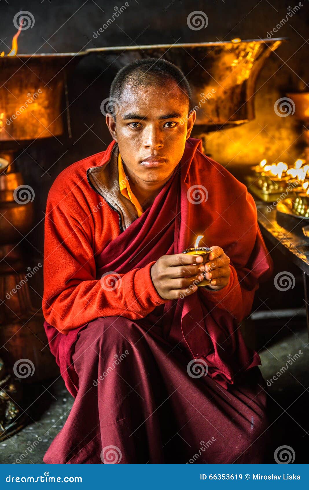 Buddhist Monk Lighting Up Candlelight in Kathmandu, Nepal Editorial