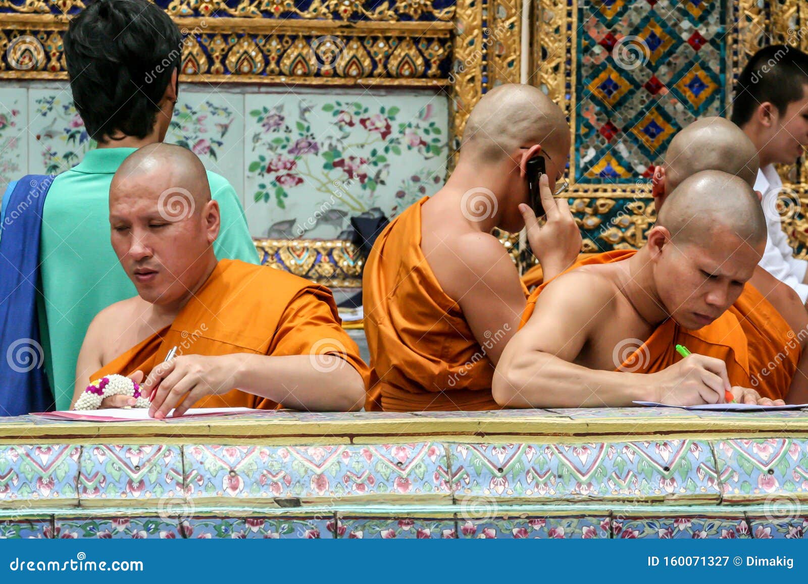 Buddhist Monk Writing the Letter and Speaking Phone. Group of