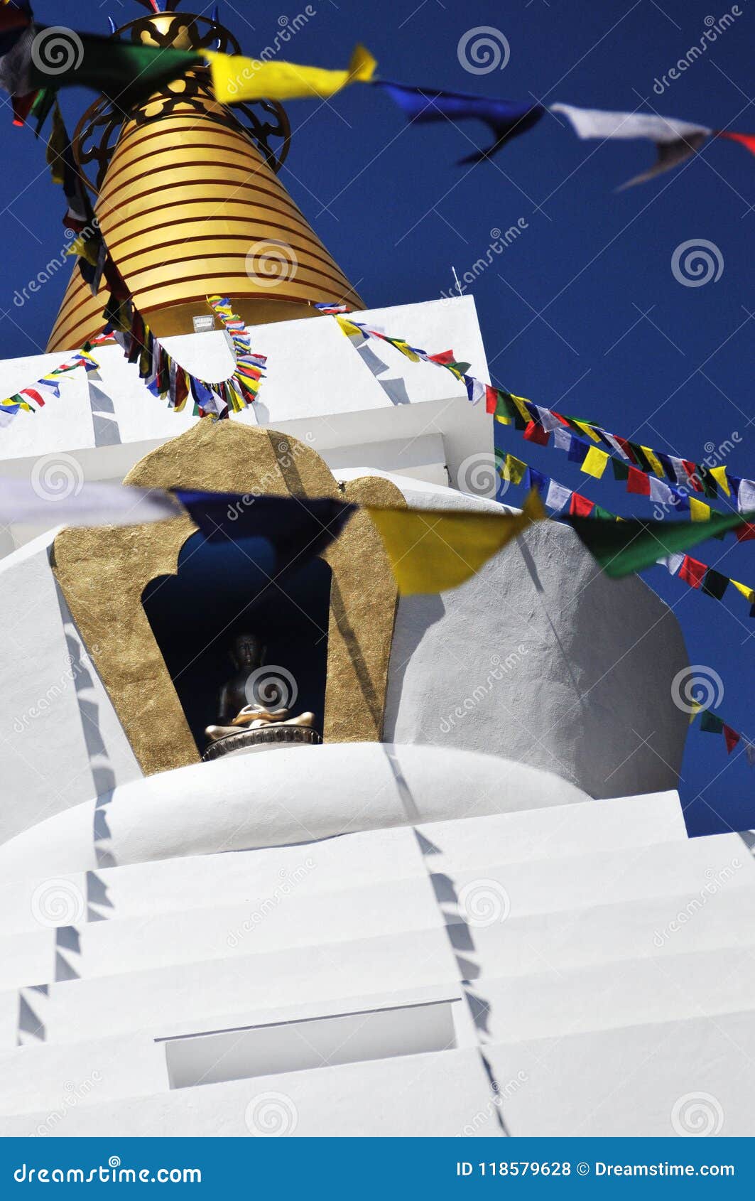 a buddhist stupa or temple, un templo budista y banderas tibetanas