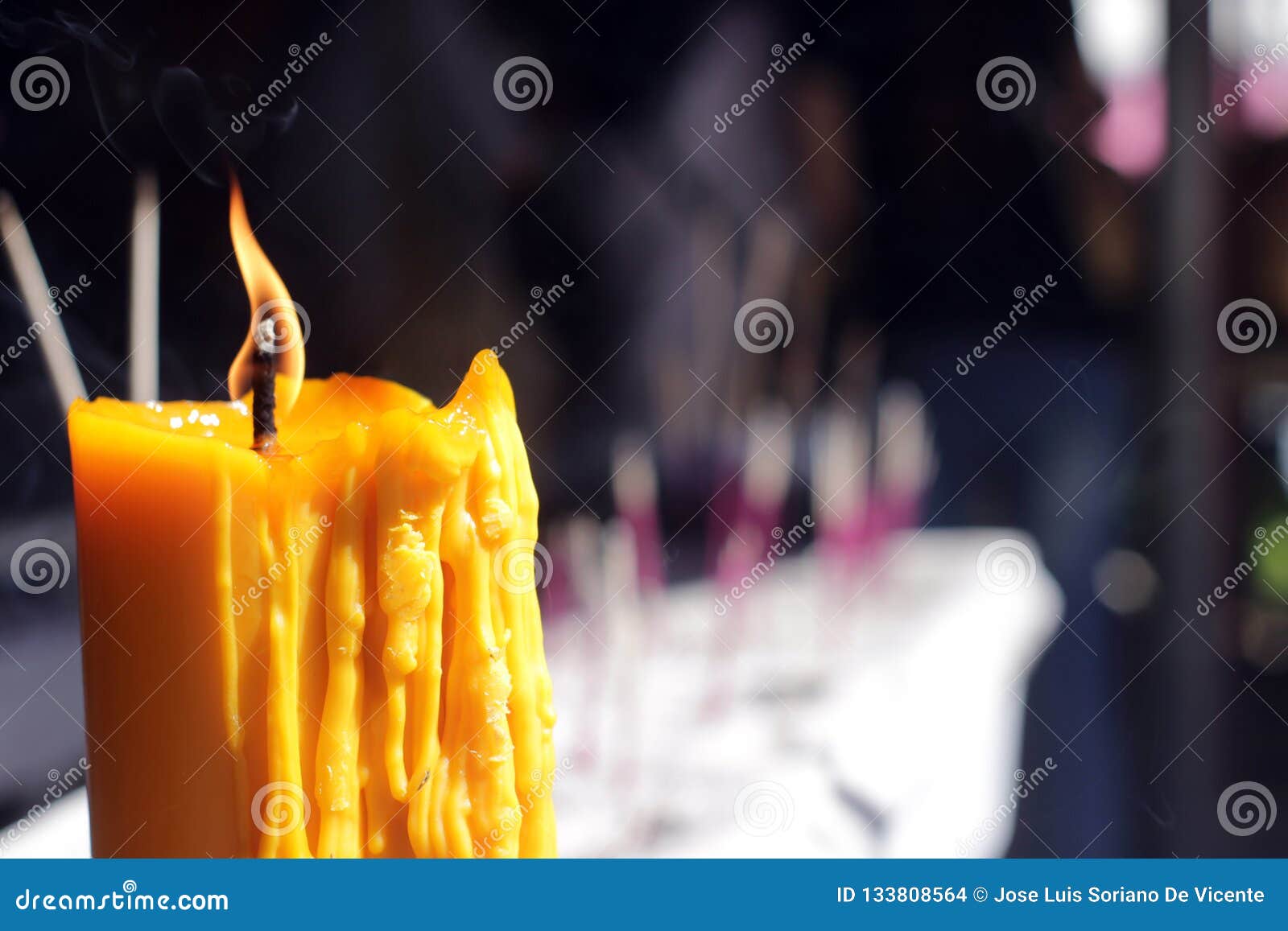 Buddhists Make Merit,Placing a Lighted Candle and Lit Incense with