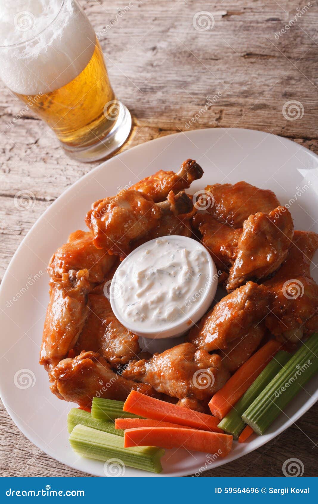Buffalo Wings and Beer on the Table Closeup Vertical Stock Photo