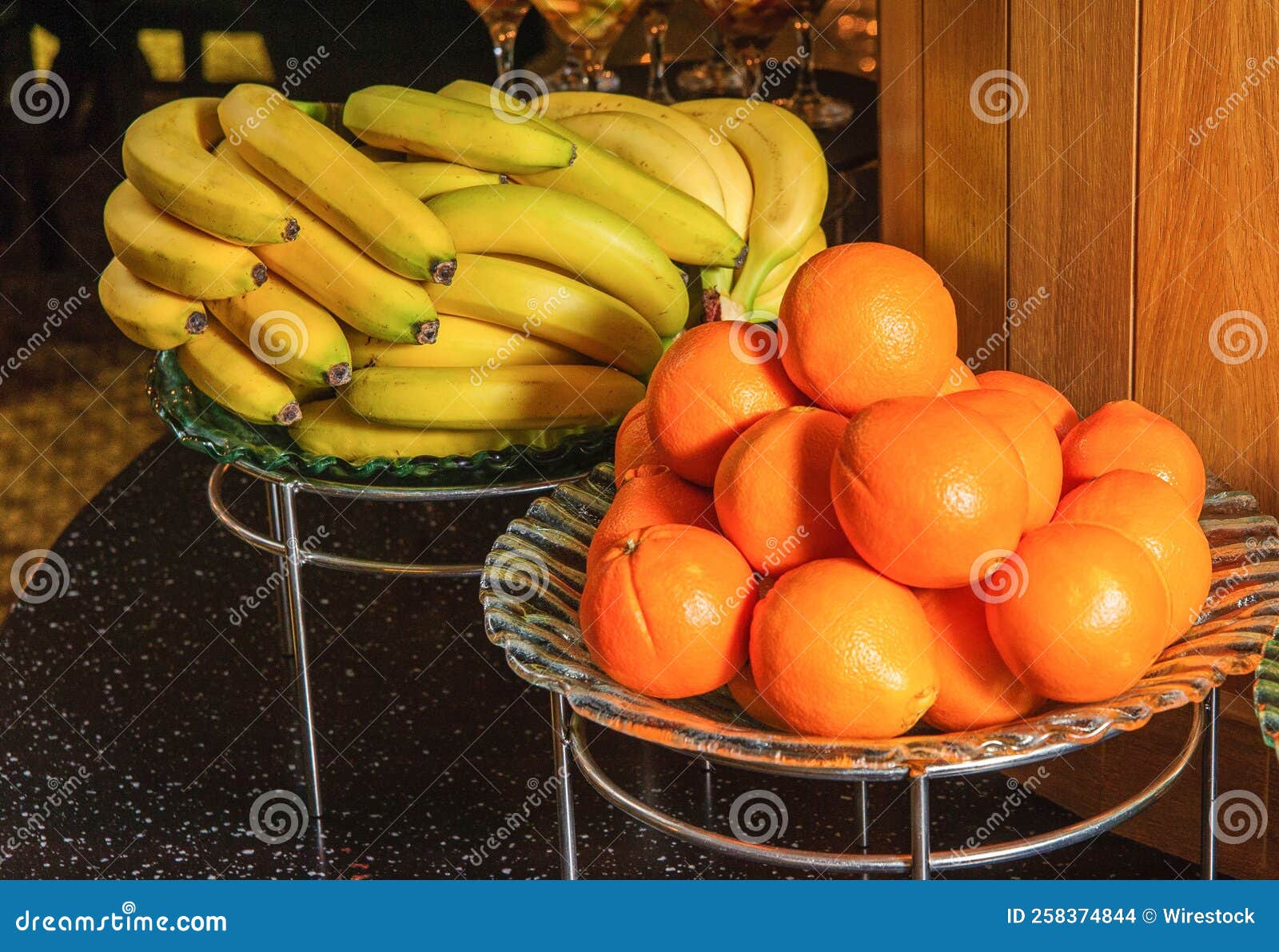 Buffet Table with Fruit Bowls Full of Bananas and Oranges Stock Photo