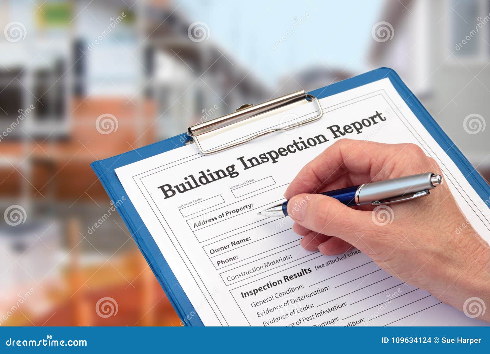 buiding inspector completing an inspection form on clipboard