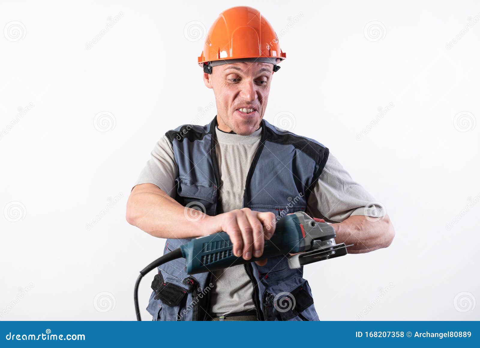 Builder with Angle Grinder, in a Helmet, with a Funny Expression on His