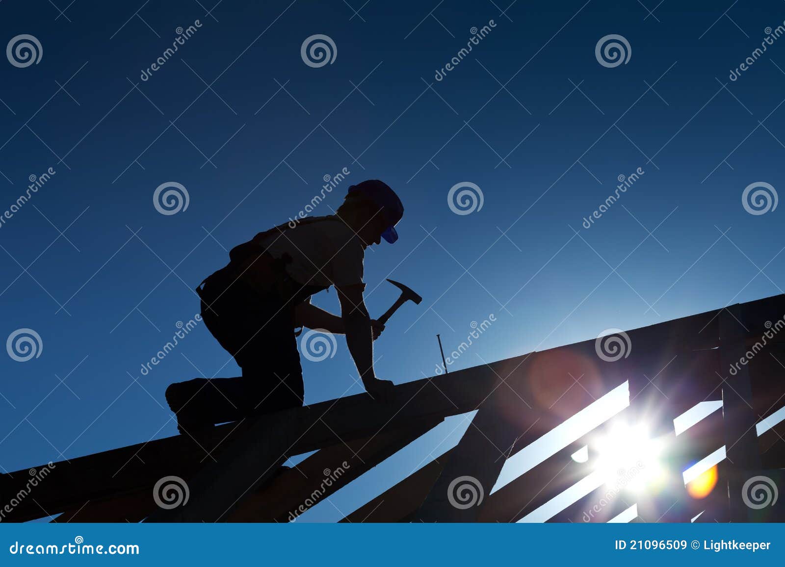 builder or carpenter working on the roof
