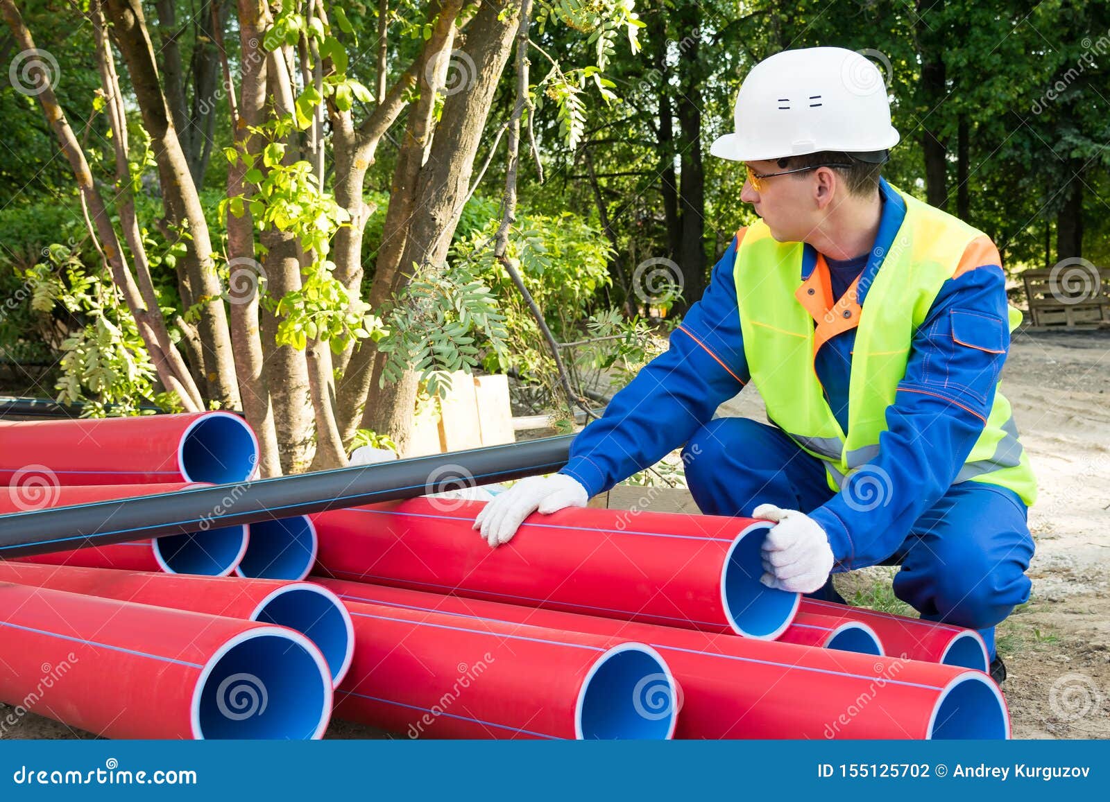 Builder Checks the Condition of Red Plastic Pipes Stock Photo Image of measurement, industrial
