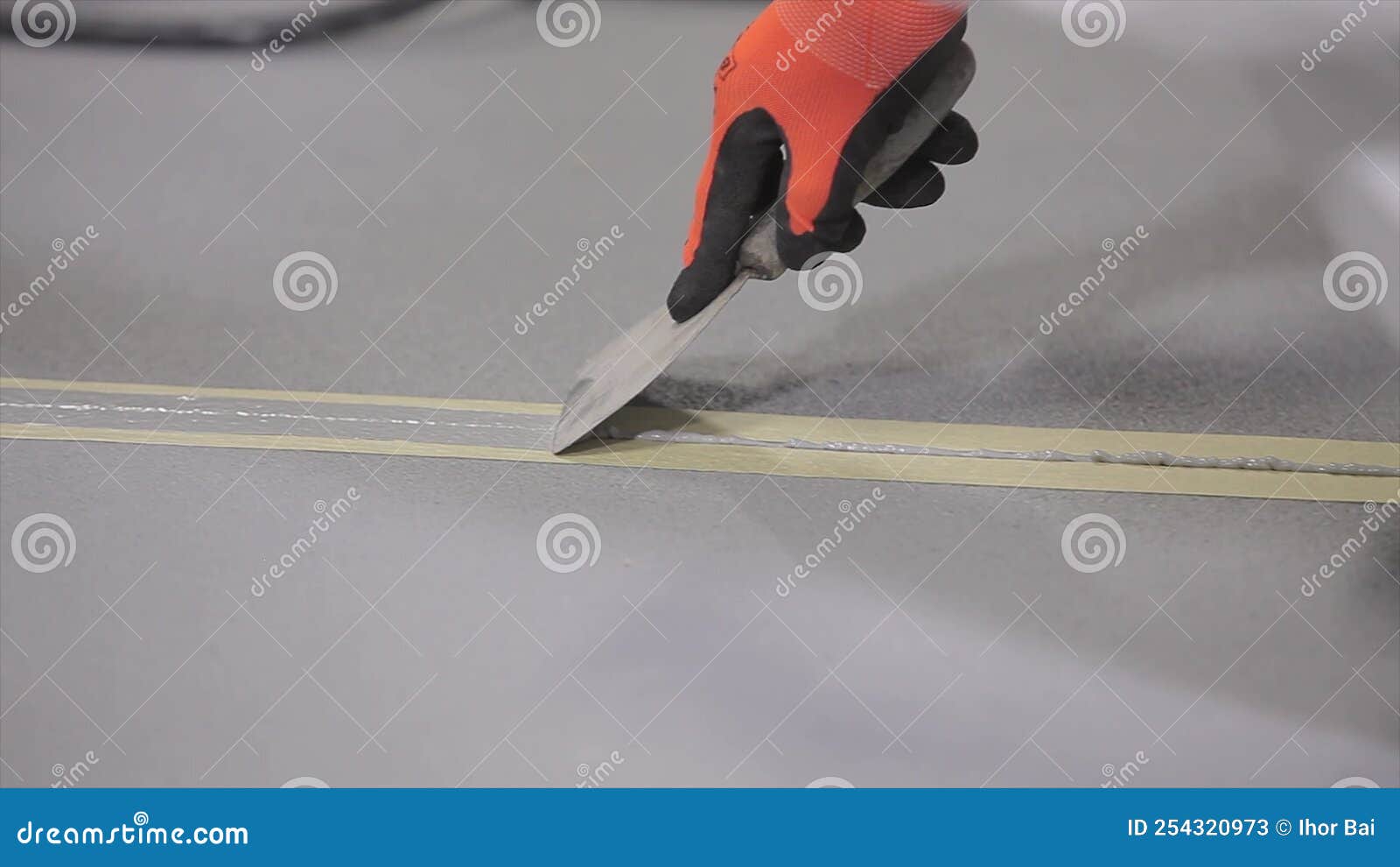 The Builder Covers the Joint Seam with Sealant. Construction Worker