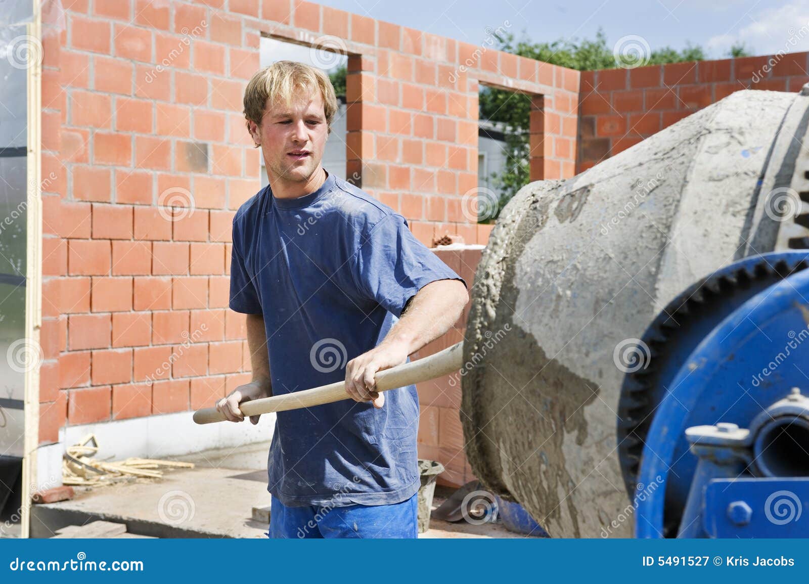 builder filling a conrete mixer