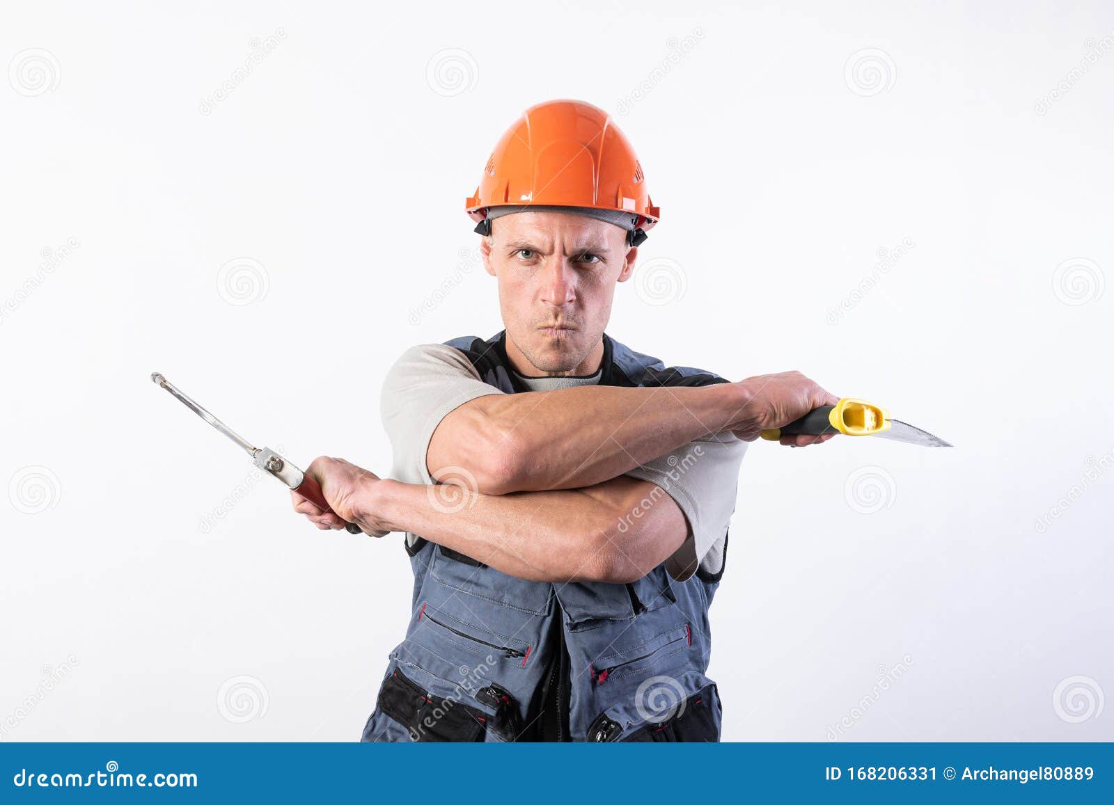 a builder with hacksaws in a helmet mocks. on a light background