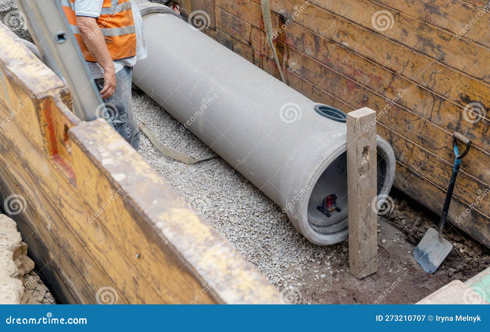 Builder Installing Big Diameter Concrete Drainage Pipe Protected by