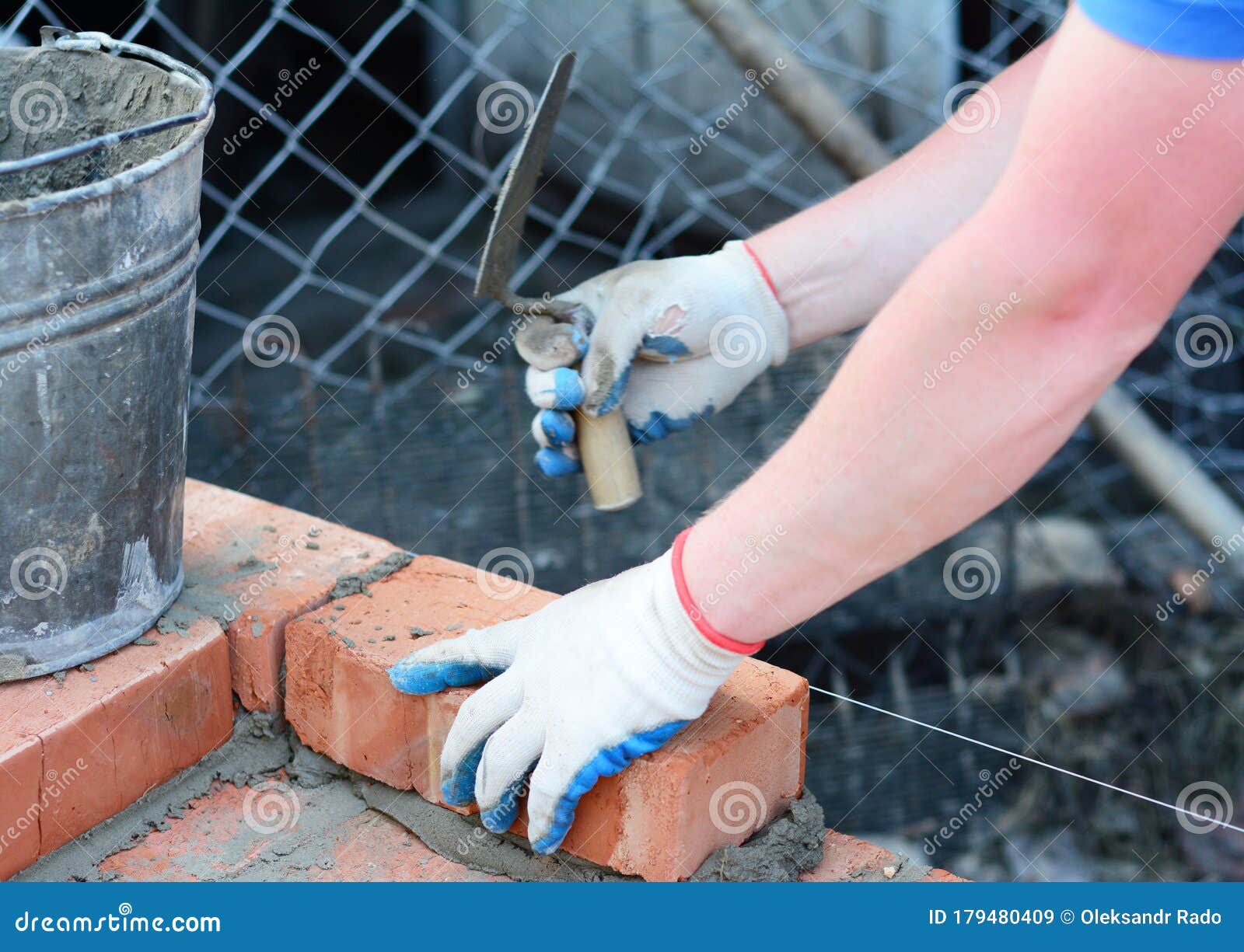 A Builder is Laying Bricks with Cement and Trowel Using Masons Line, String  Line and Spirit Level Stock Image - Image of trowel, tool: 179480409