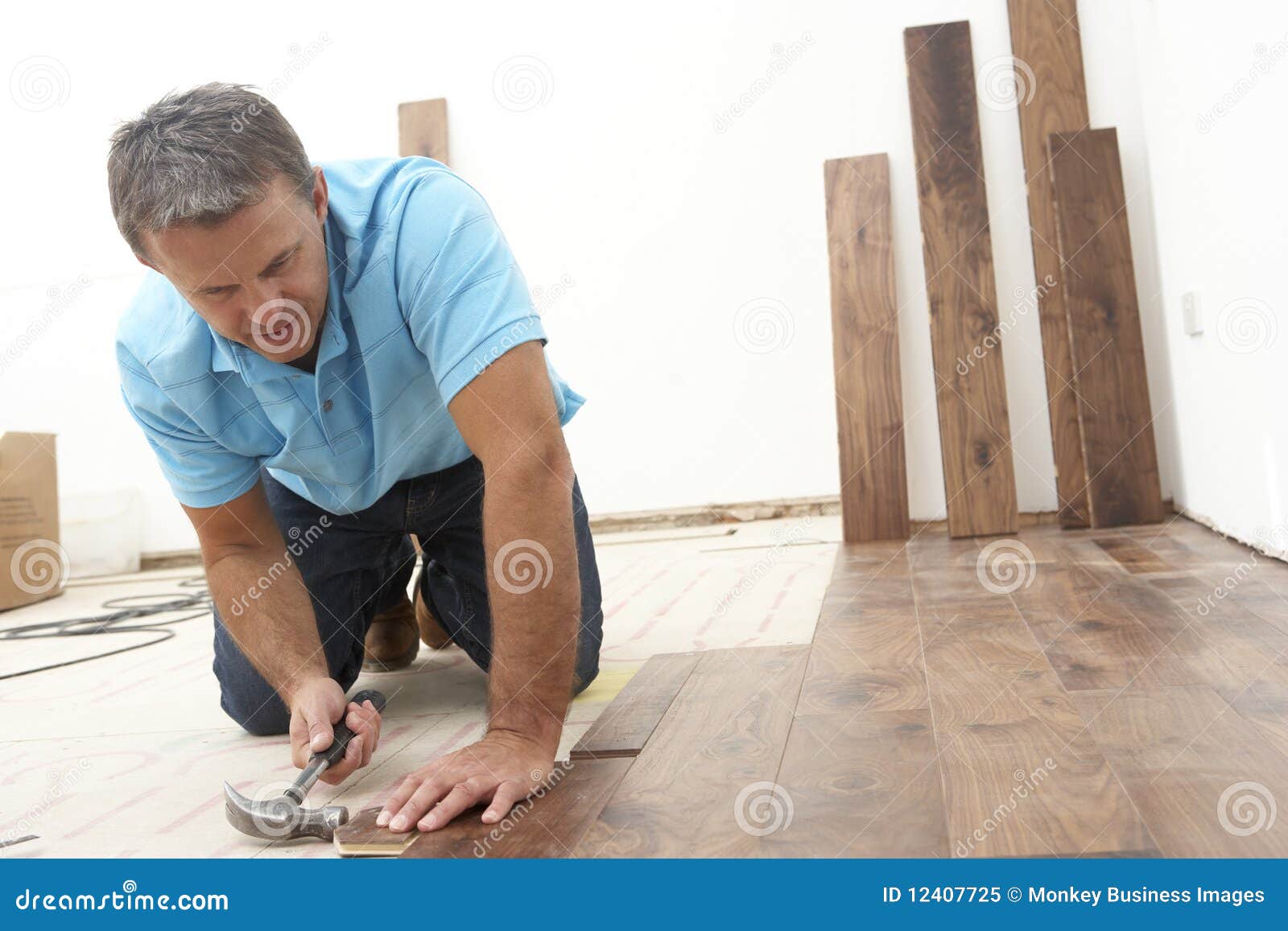 builder laying wooden flooring