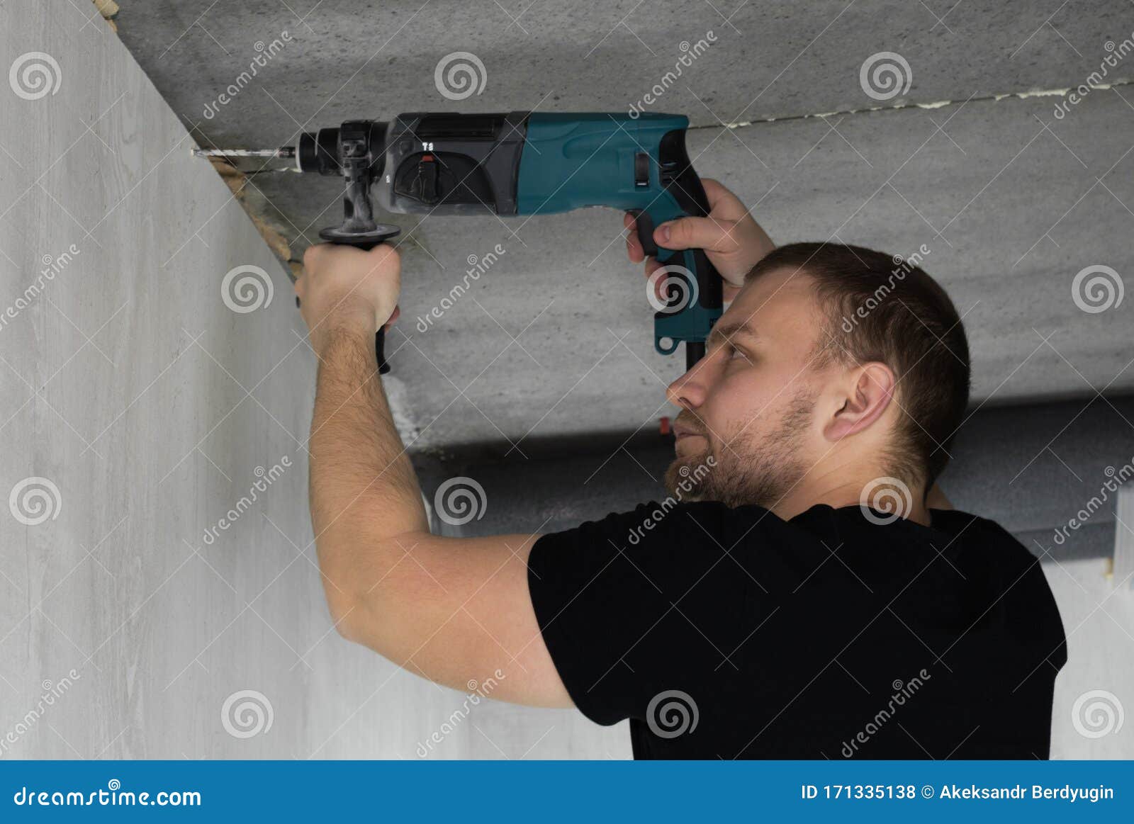 Builder Makes a Hole in a Concrete Wall with Hammer Drill. 4k Footage Stock Photo Image of