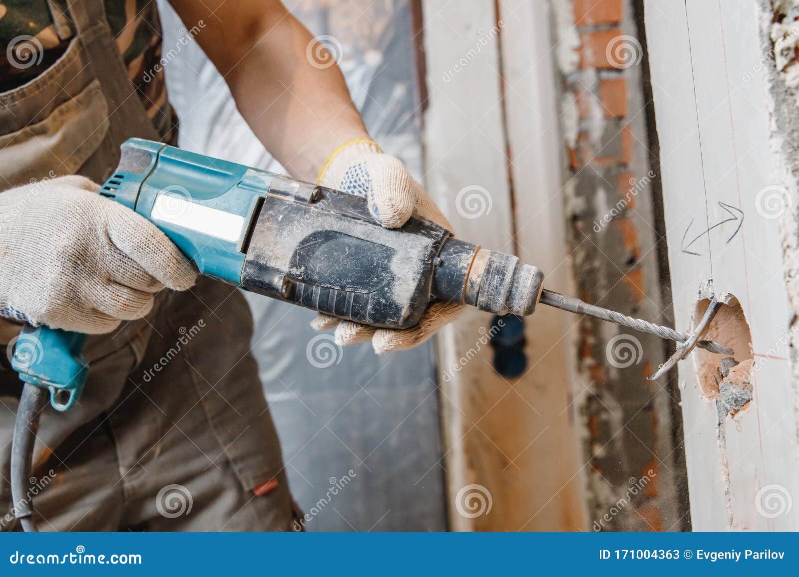 Builder Man Cutting Electrical Chase in Concrete Wall with Hammer Drill Diamond Crown Stock