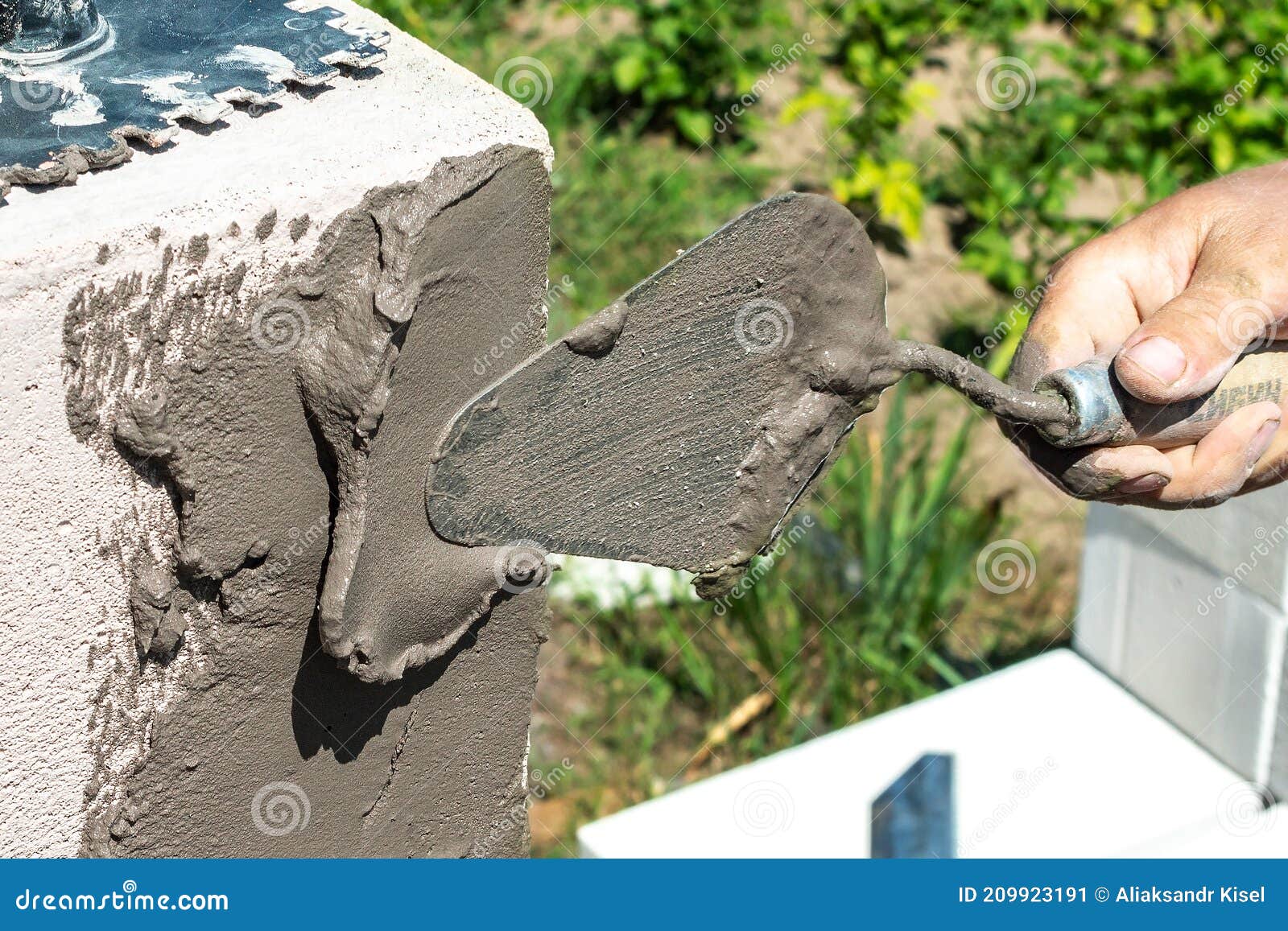 The Builder Puts the Mortar Under the Brickwork with a Trowel. Building