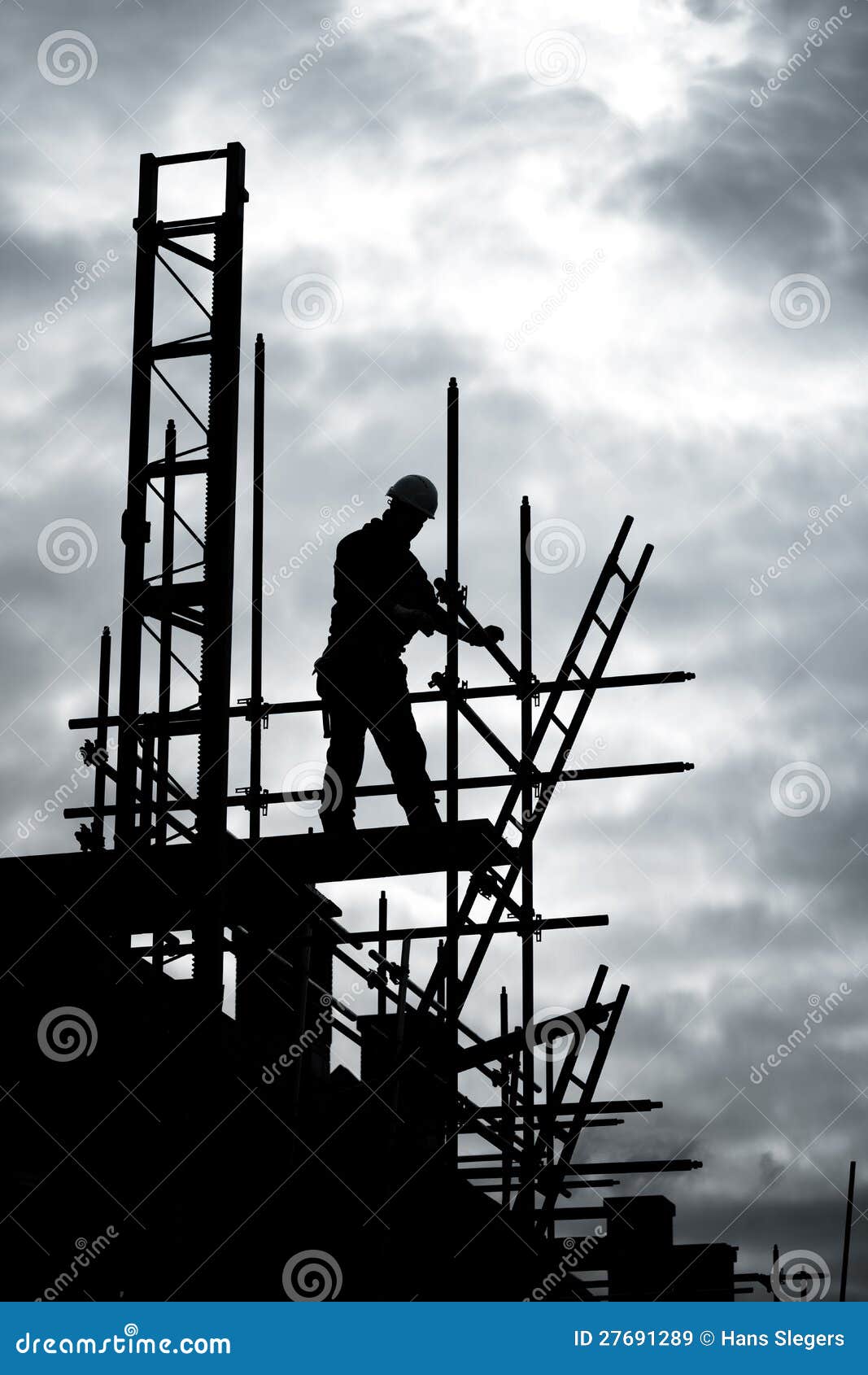 builder on scaffold building site