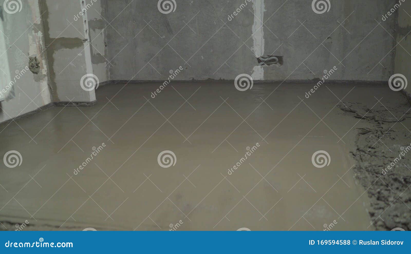 builder smoothing wet mortar floor pouring concrete worker uses spatula to level wet concrete floor leveling floor 169594588