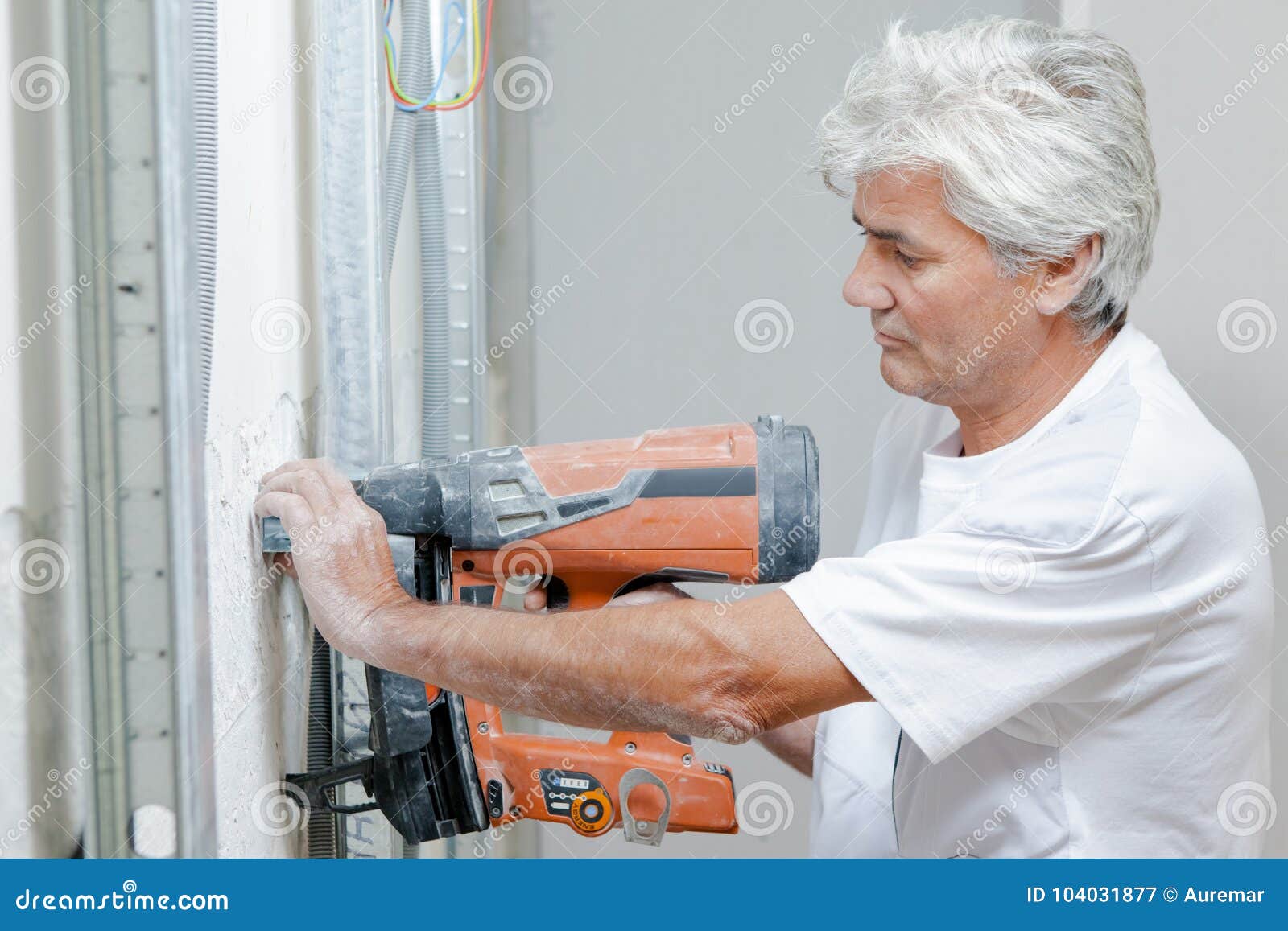 Builder using nail gun stock image. Image of arms, vertical 104031877