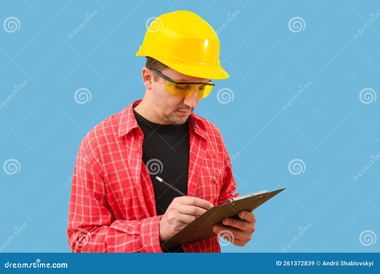 Builder or Worker in a Construction Helmet on a Blue Background Stock
