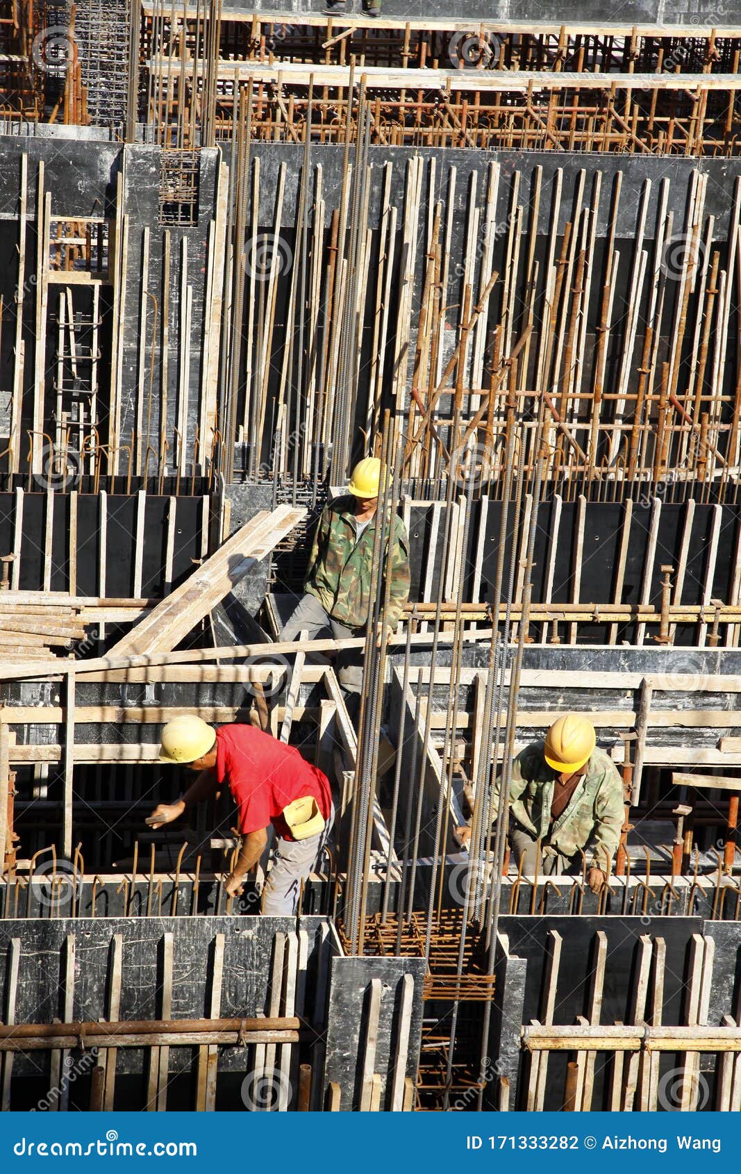 Builder Worker Knitting Metal Rods Bars into Framework Reinforcement