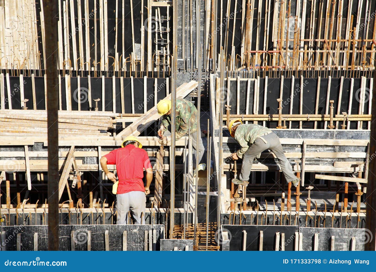 Builder Worker Knitting Metal Rods Bars into Framework Reinforcement