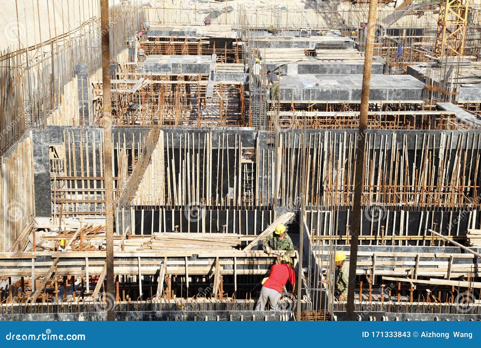 Builder Worker Knitting Metal Rods Bars into Framework Reinforcement