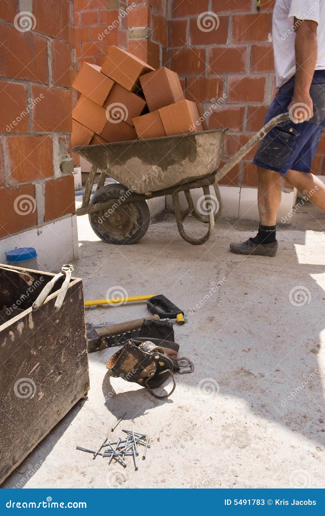 Builders Carrying a Wheelbarrow Under Construction Stock Image Image
