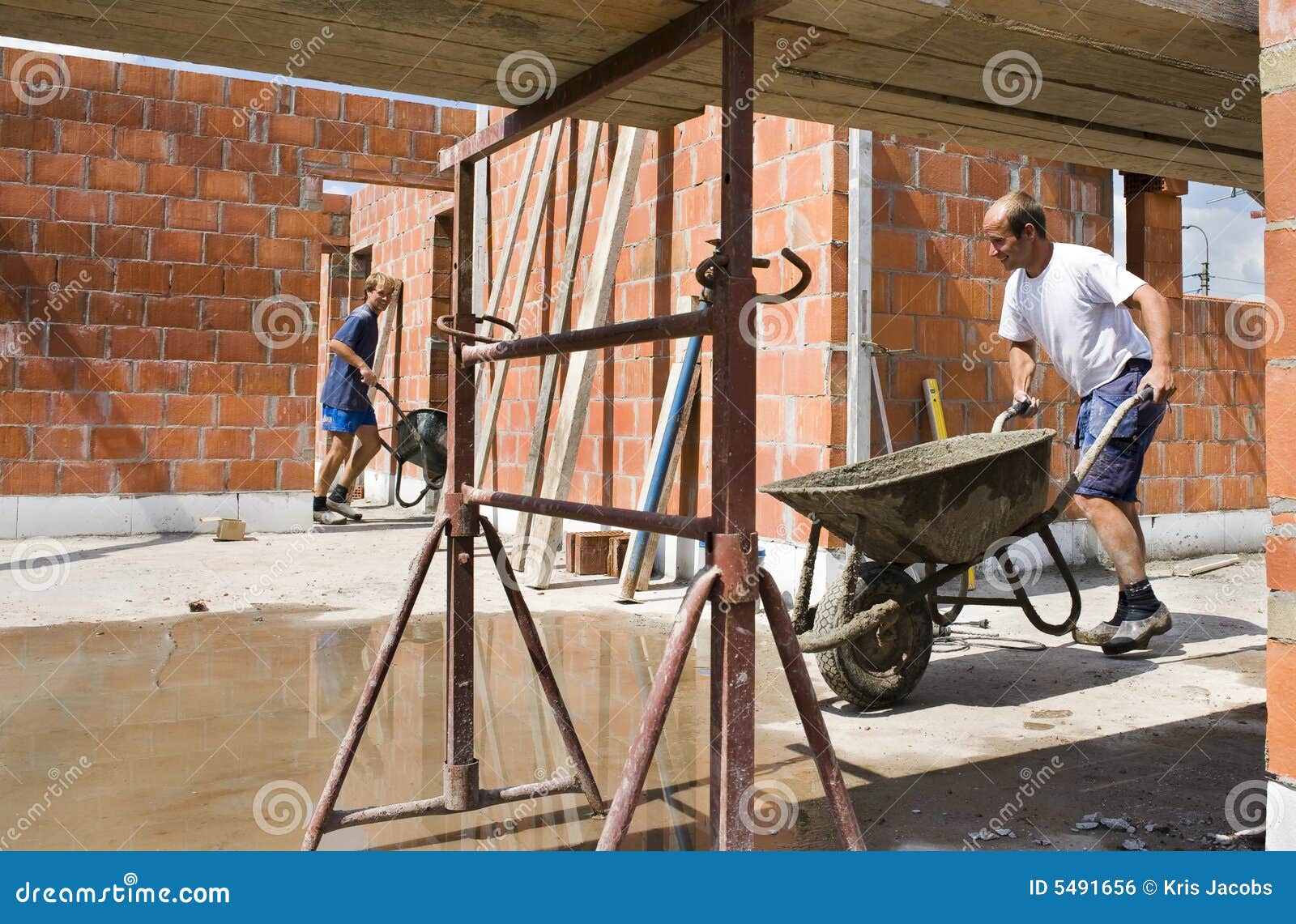 builders carrying wheelbarrows