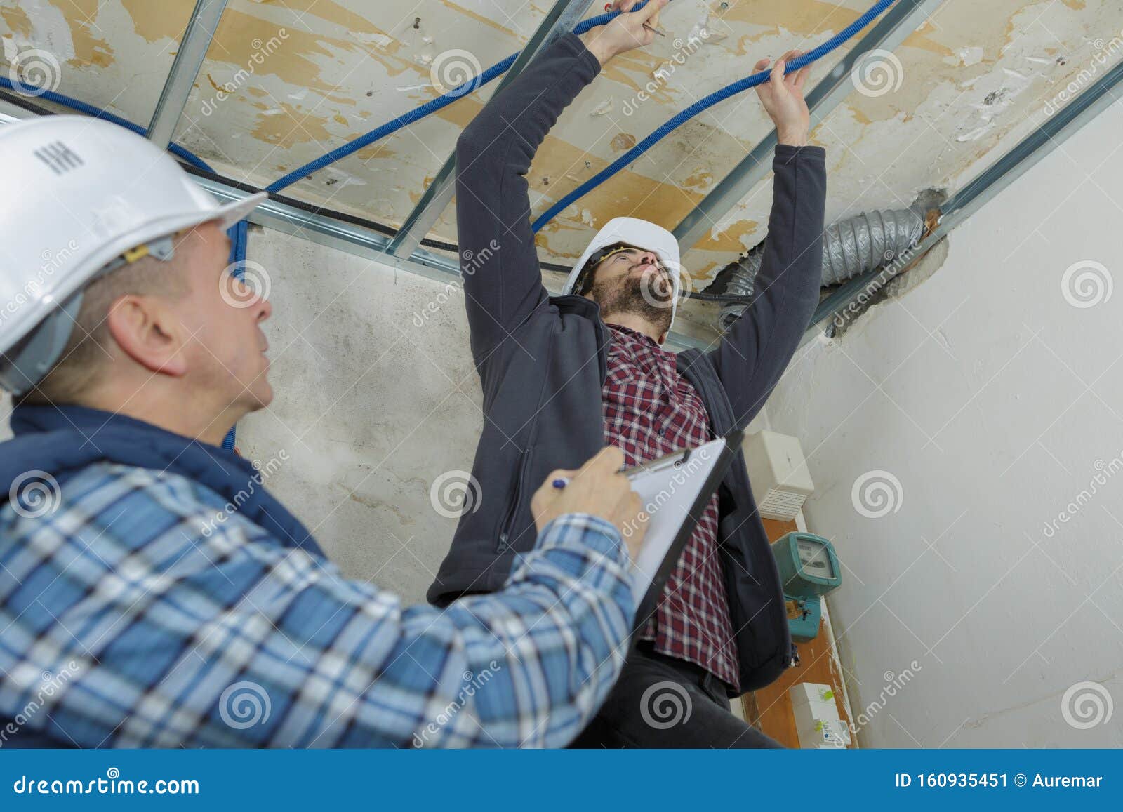 Builders Putting Or Repairing Up Suspended Ceiling Stock Image