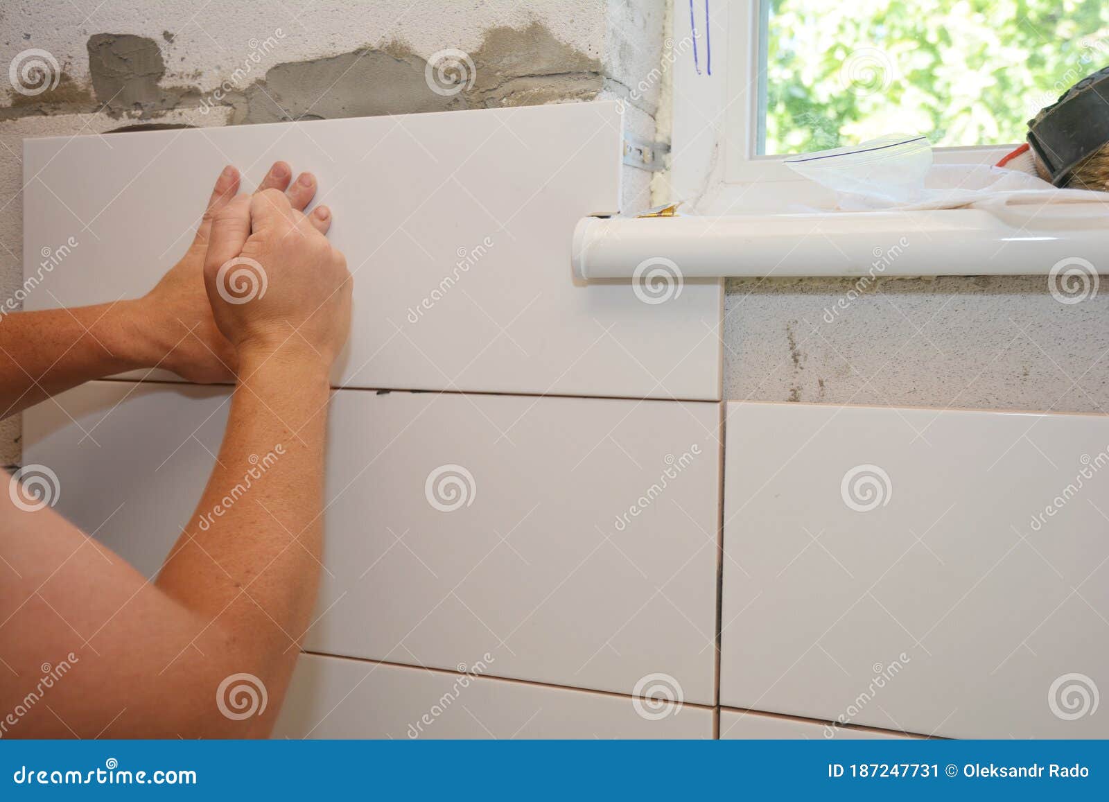 A Building Contractor is Installing Ceramic Tiles in the Problem Area