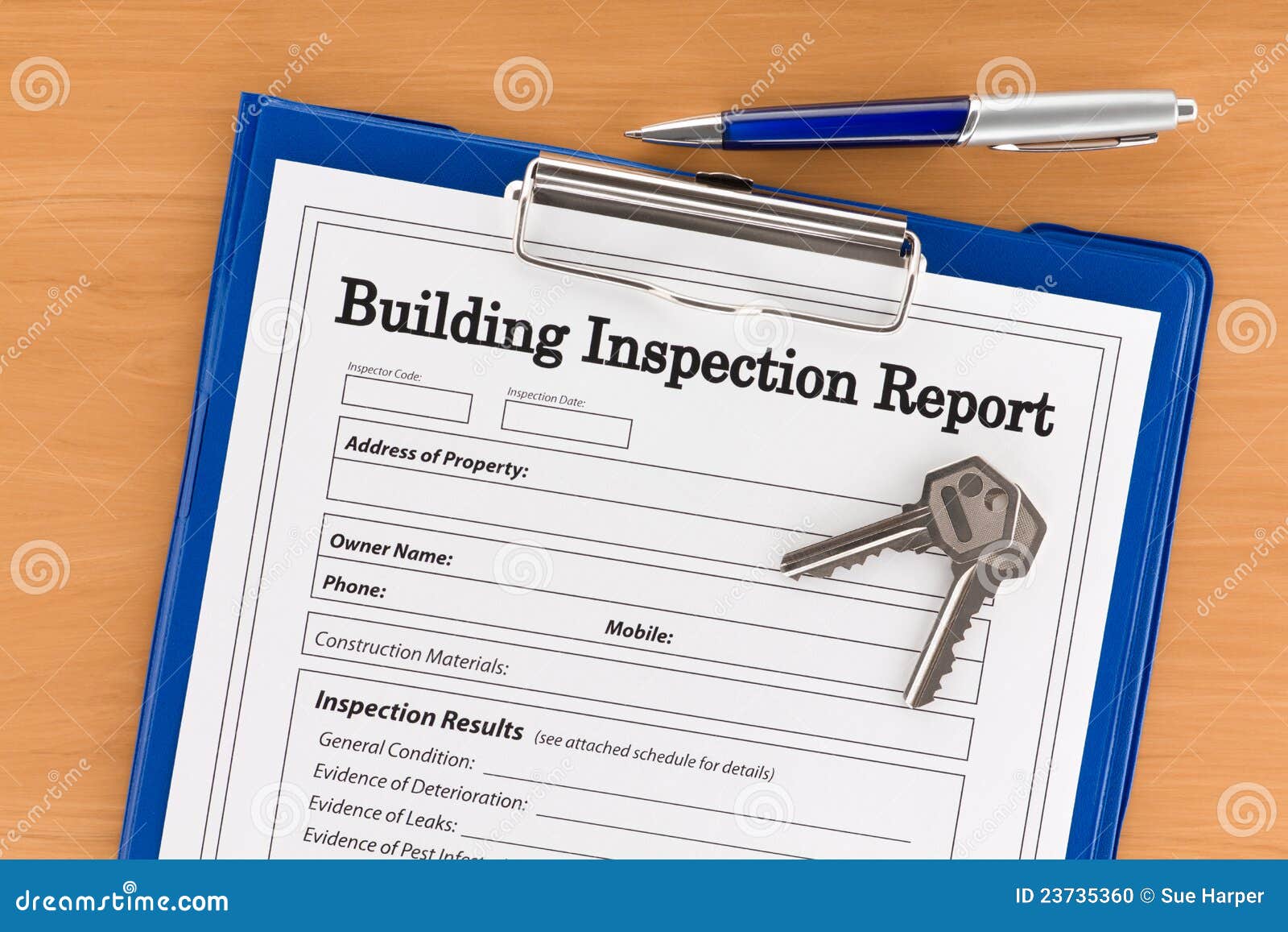 building inspection report with pen and keys