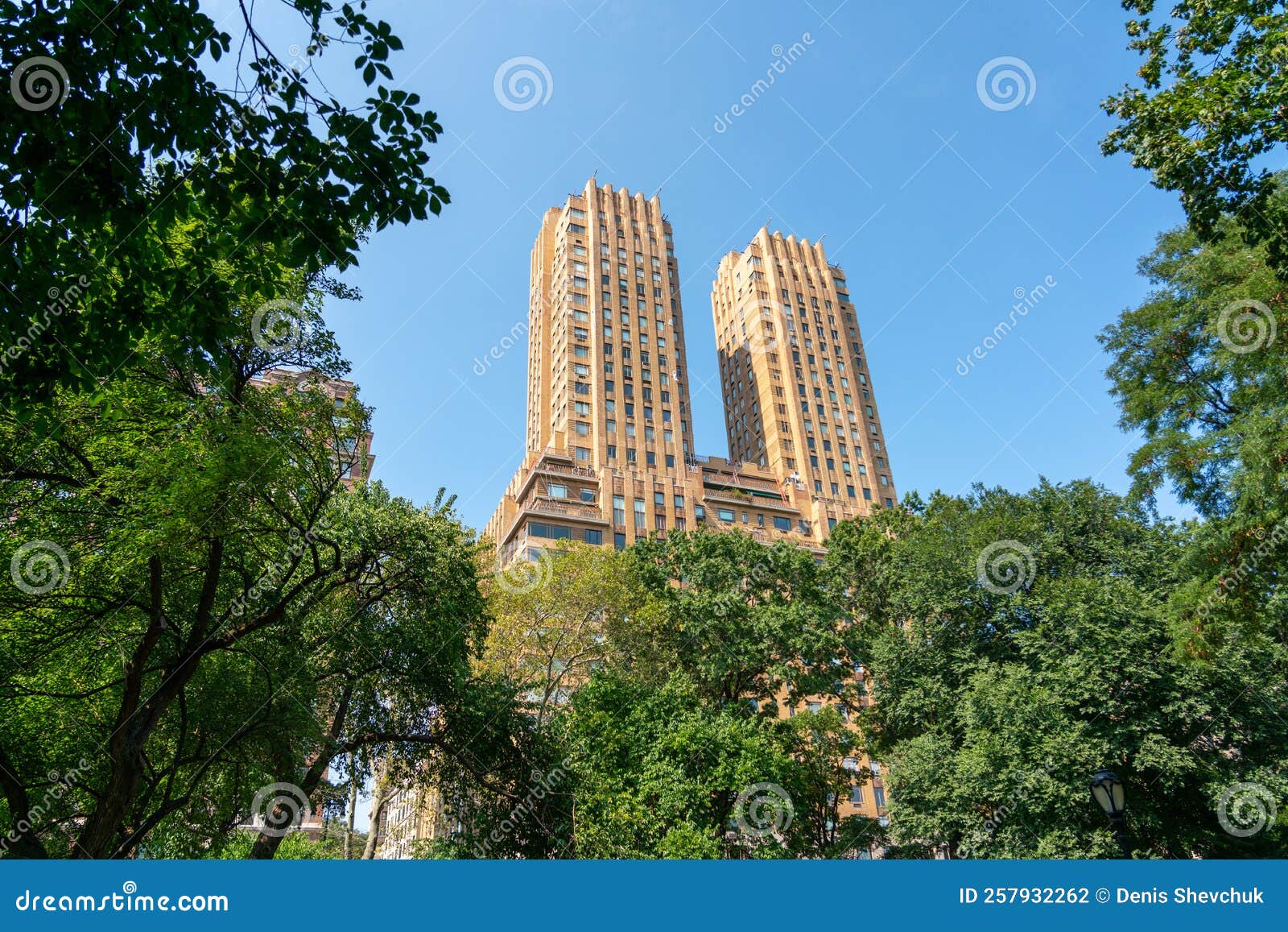 building majestic apartments above the green trees of central park in manhattan
