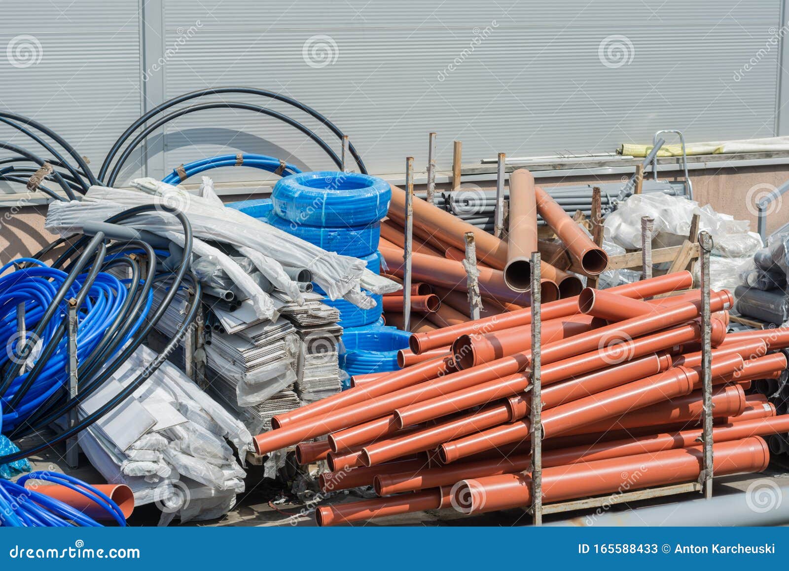 building materials in the yard. plastic pipes, hoses, plastic, plastic film, cables, plastic panels in the package, corrugation