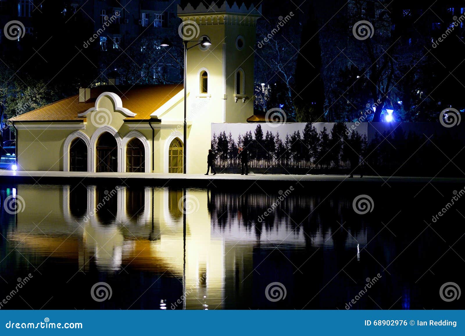 building reflected in lake in dede gorgud park, baku, azerbaijan