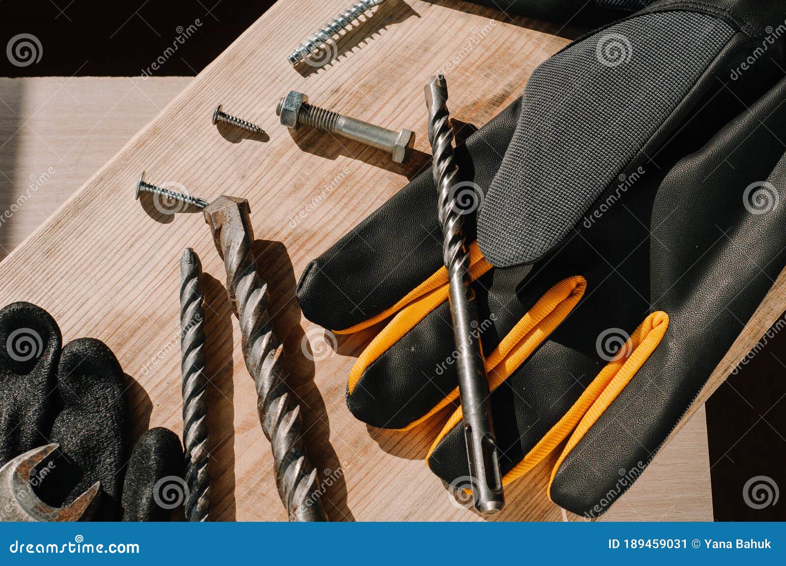 building tools including centimeter ruler, wrench and cutter placed in the right side on wooden surface with open space.