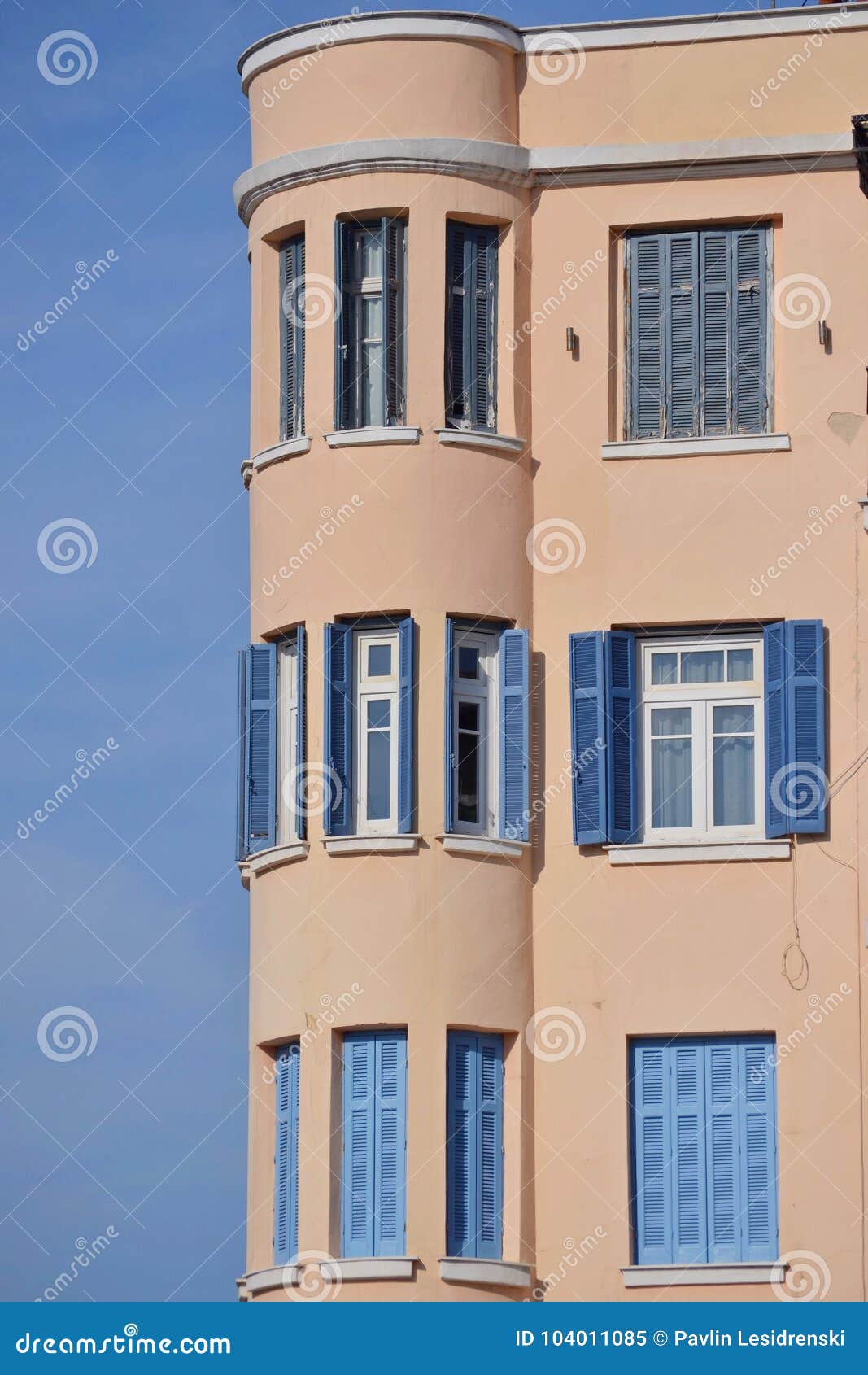 Building with white windows and blue dormers. Building with white windows and blue skylights. Shot in the open.