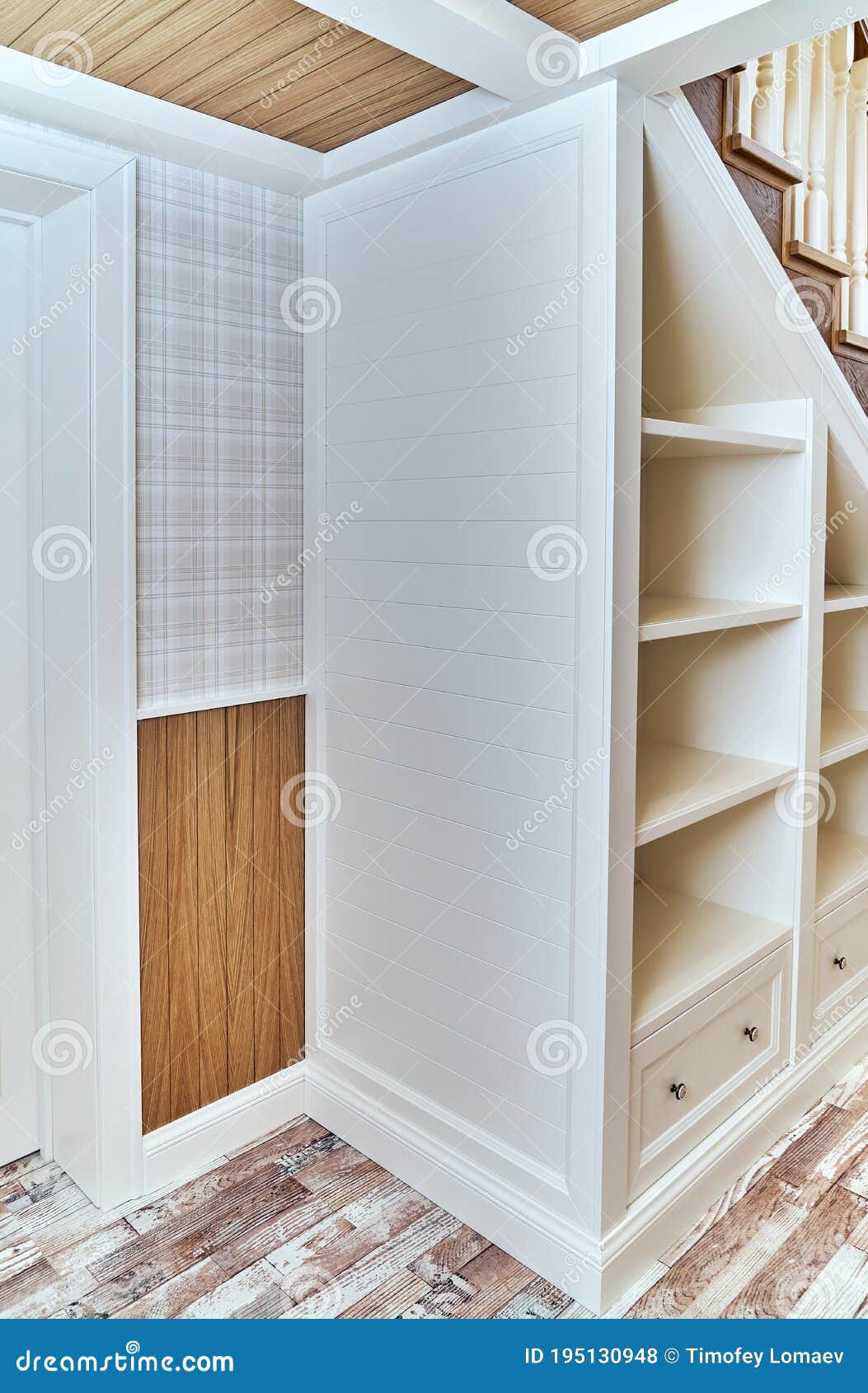Builtin Bookcase Under a Wooden Staircase with White Balusters Stock