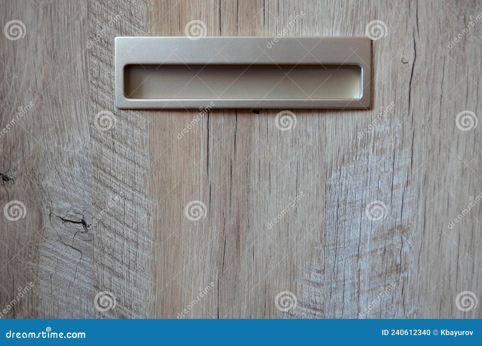 built-in handle in a wooden chest of drawers close-up front view