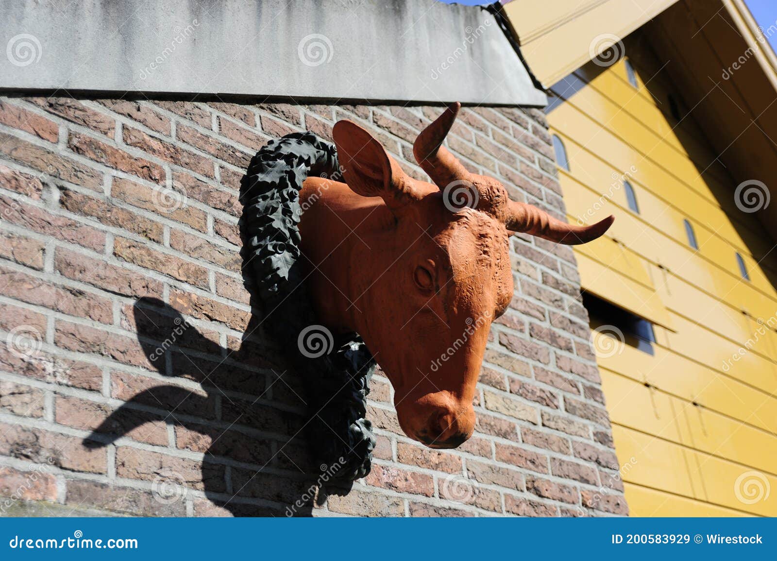 Bull Head Sculpture on the Building Under the Sunlight Stock Image