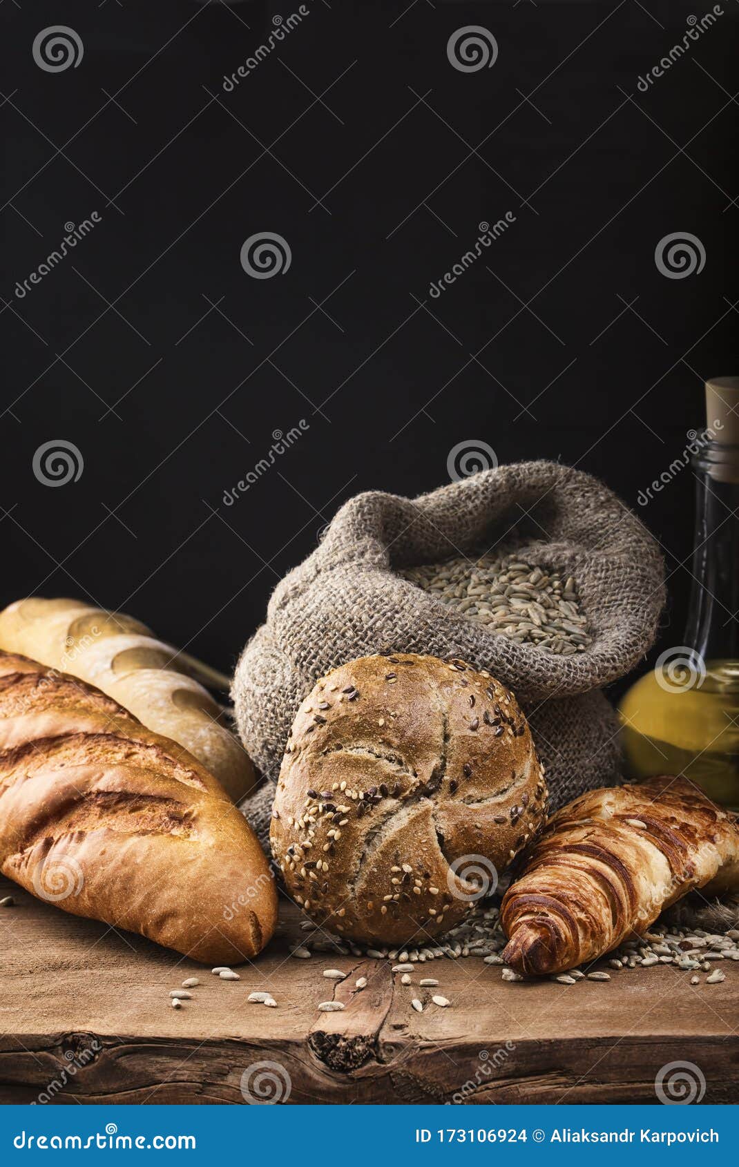 A Bun Croissant Bread Baguette Olive Oil And Grain In A Bag Lie
