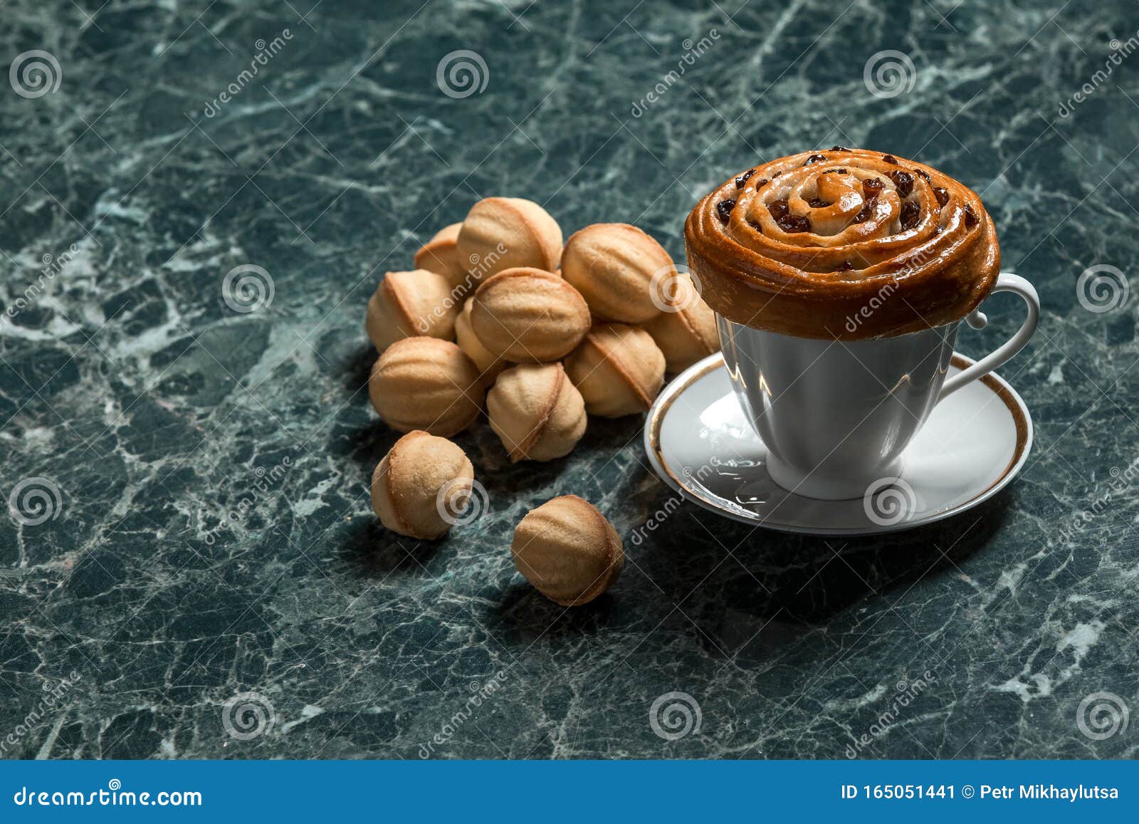 Bun with Raisins with Saucer, Black Tea on Cookie Walnut on Marble ...