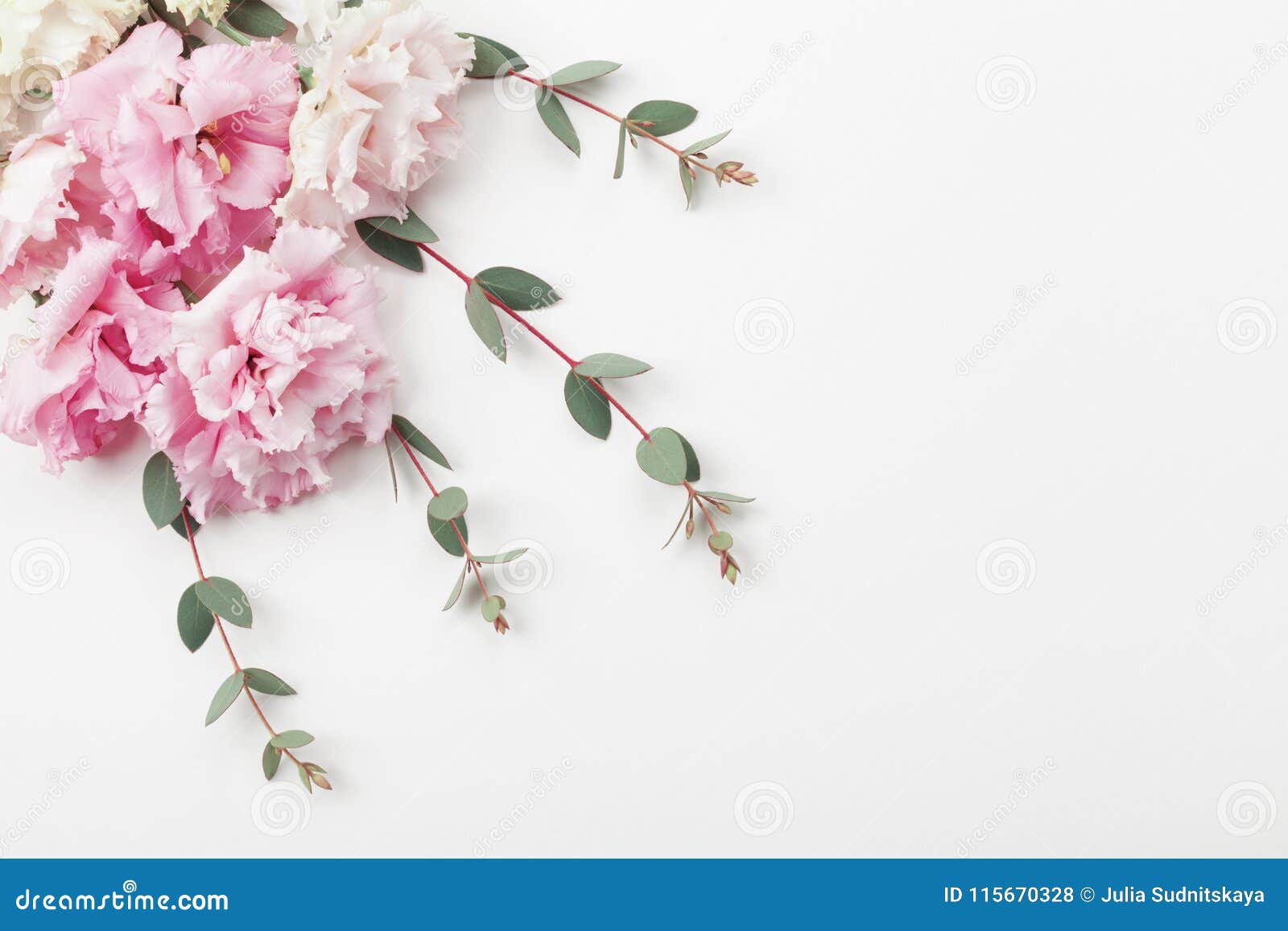 bunch of beautiful flowers and eucalyptus leaves on white table top view. flat lay style.