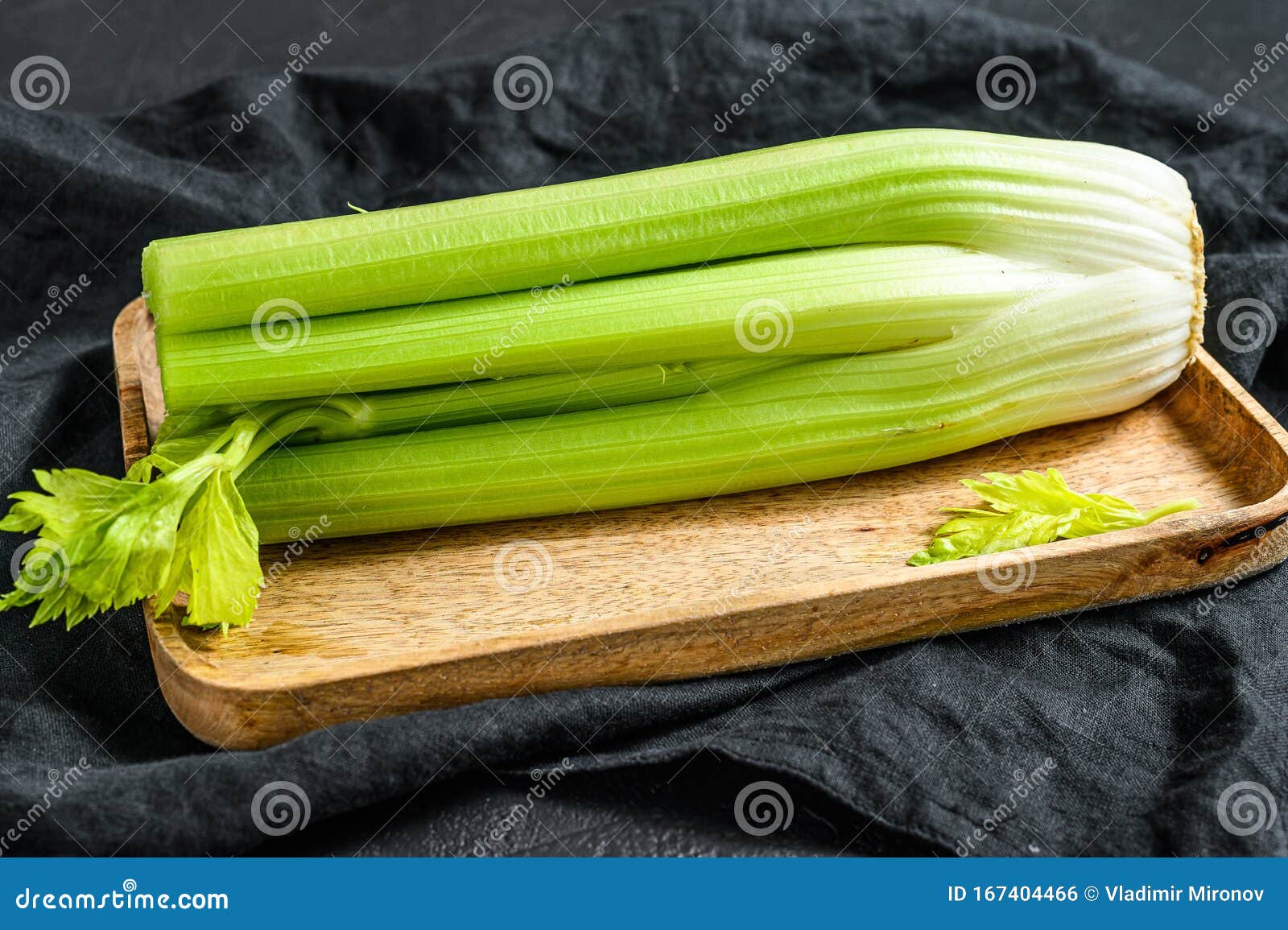 Bunch of Fresh Celery Stalk with Leaves. Black Background Stock Photo