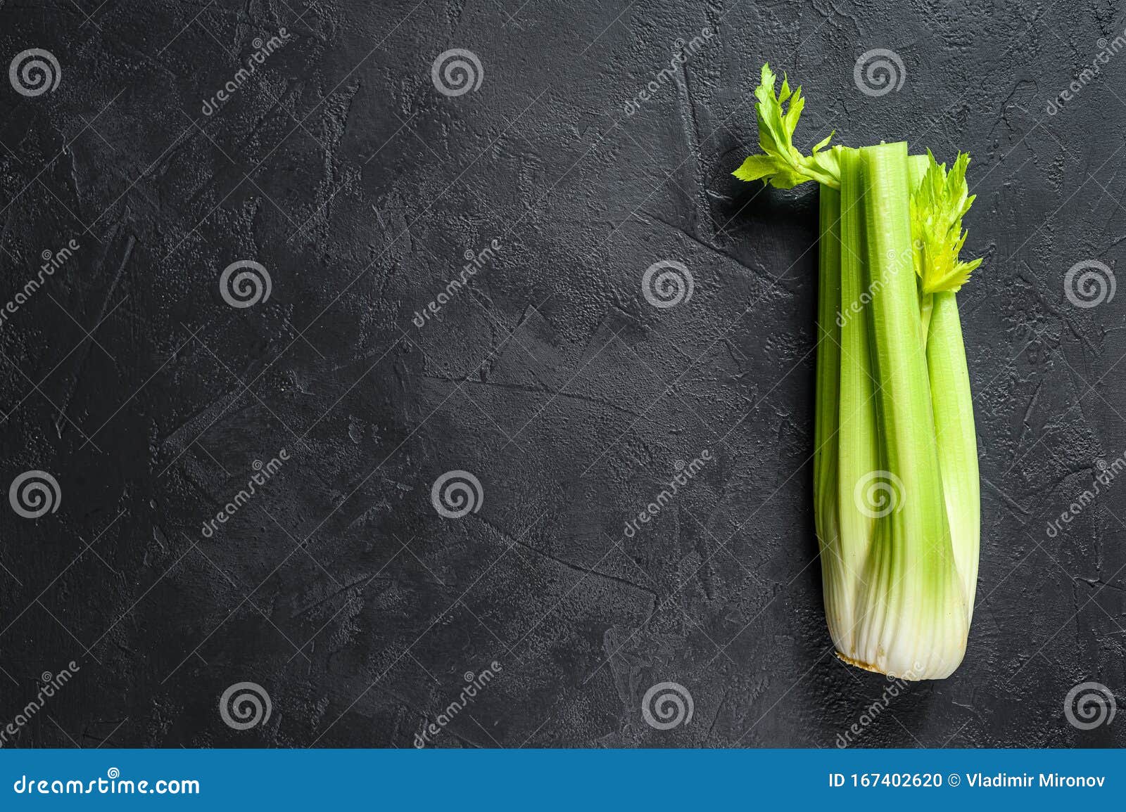 Bunch of Fresh Celery Stalk with Leaves. Black Background. Top View