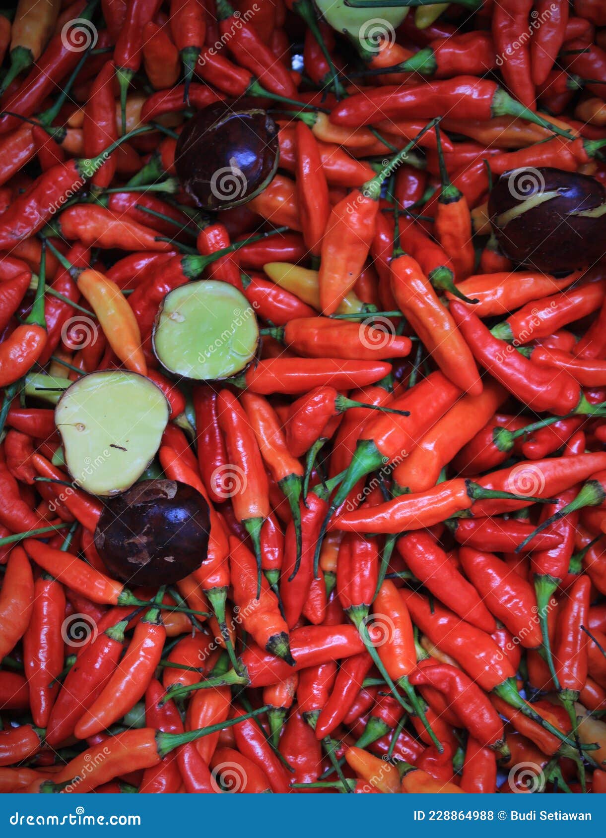 a bunch of fresh red cayenne pepper mixed with jengkol or dogfruit