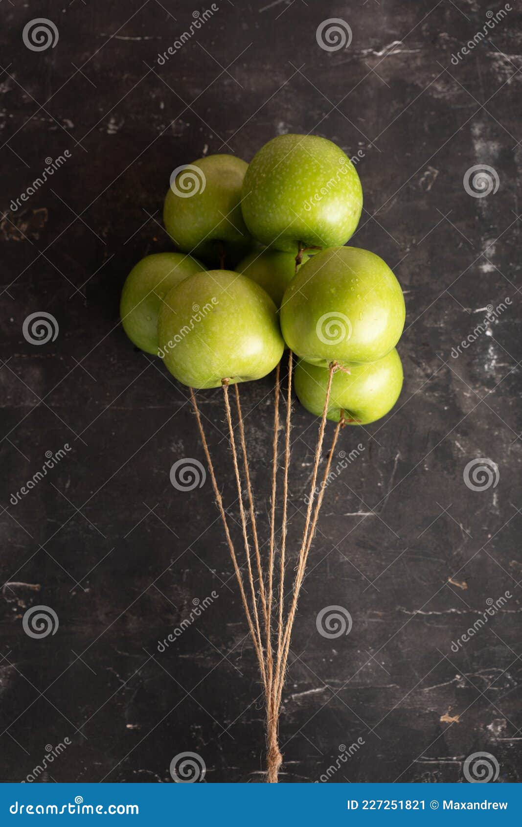 bunch of green apples on a string like air balloons. selective focus
