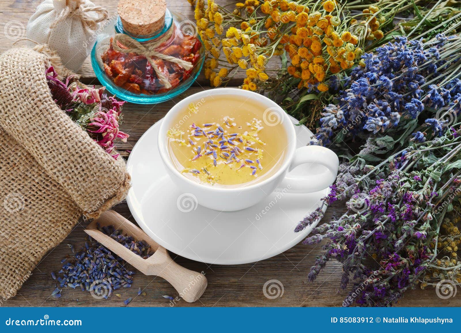 bunch of medicinal herbs, healthy tea and bag of dry herbs.